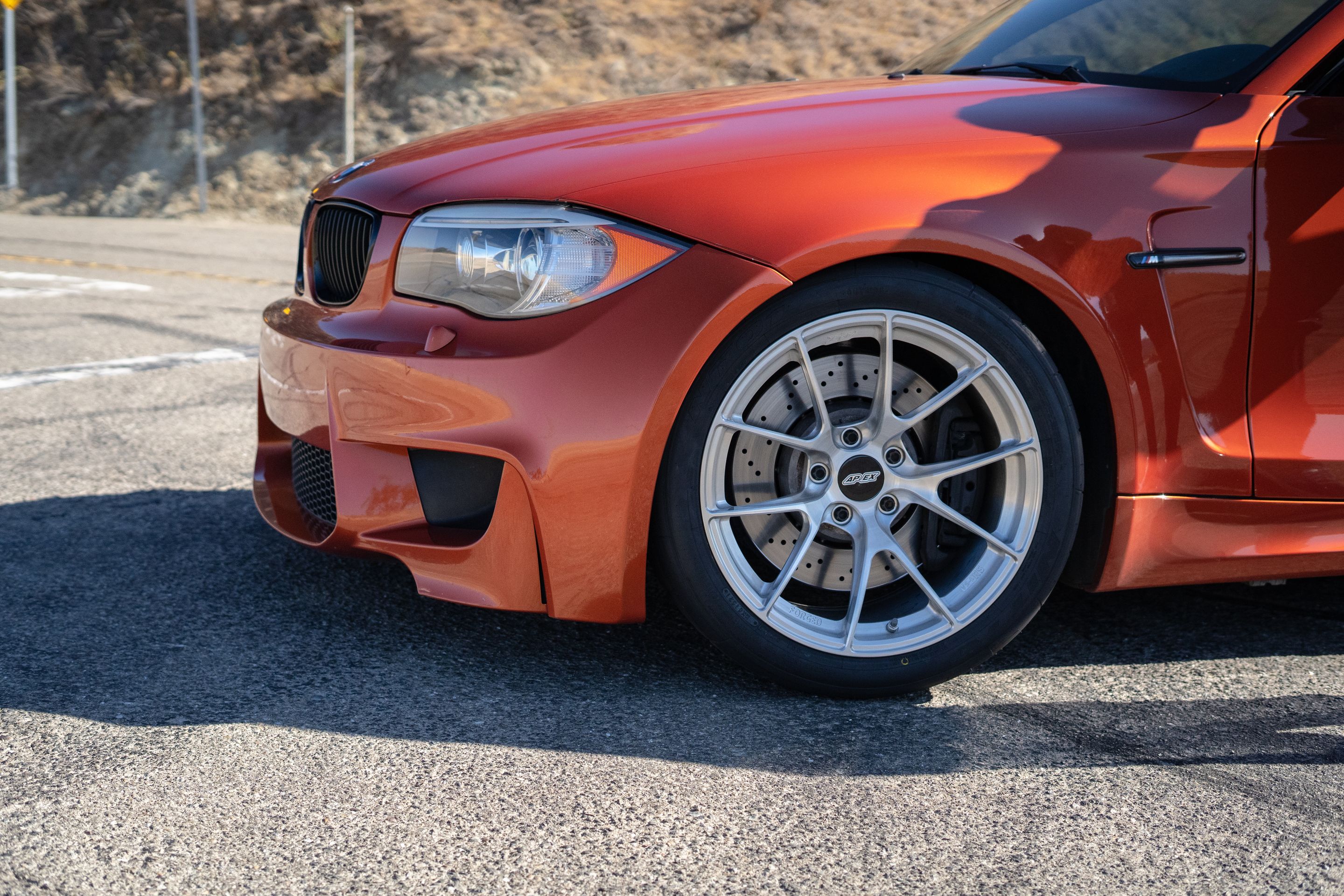 Orange BMW E82 1M with 18" VS-5RS Apex wheels in Brushed Clear