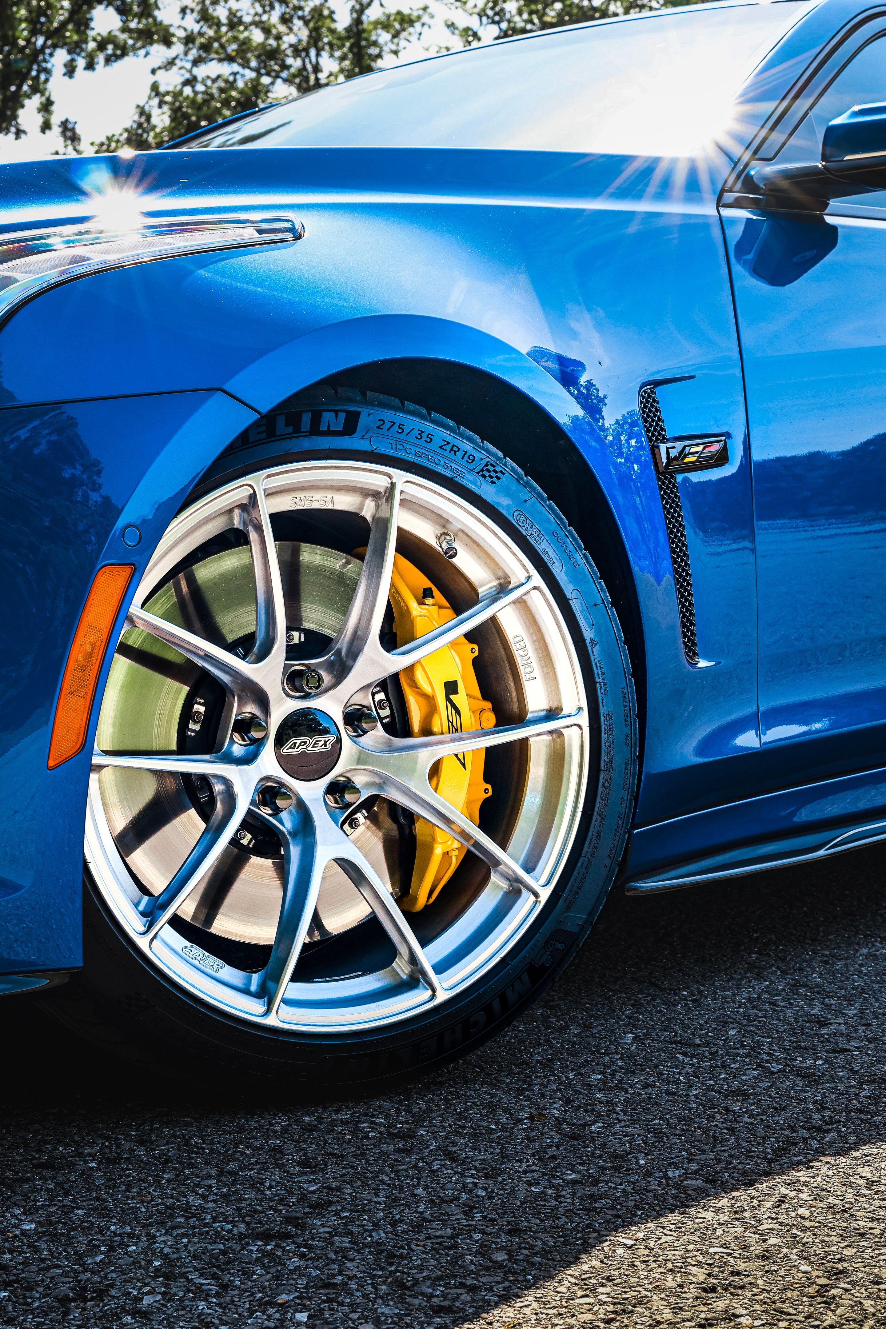 Blue Cadillac Gen 3 CTS-V with 19" VS-5RS Apex wheels in Brushed Clear