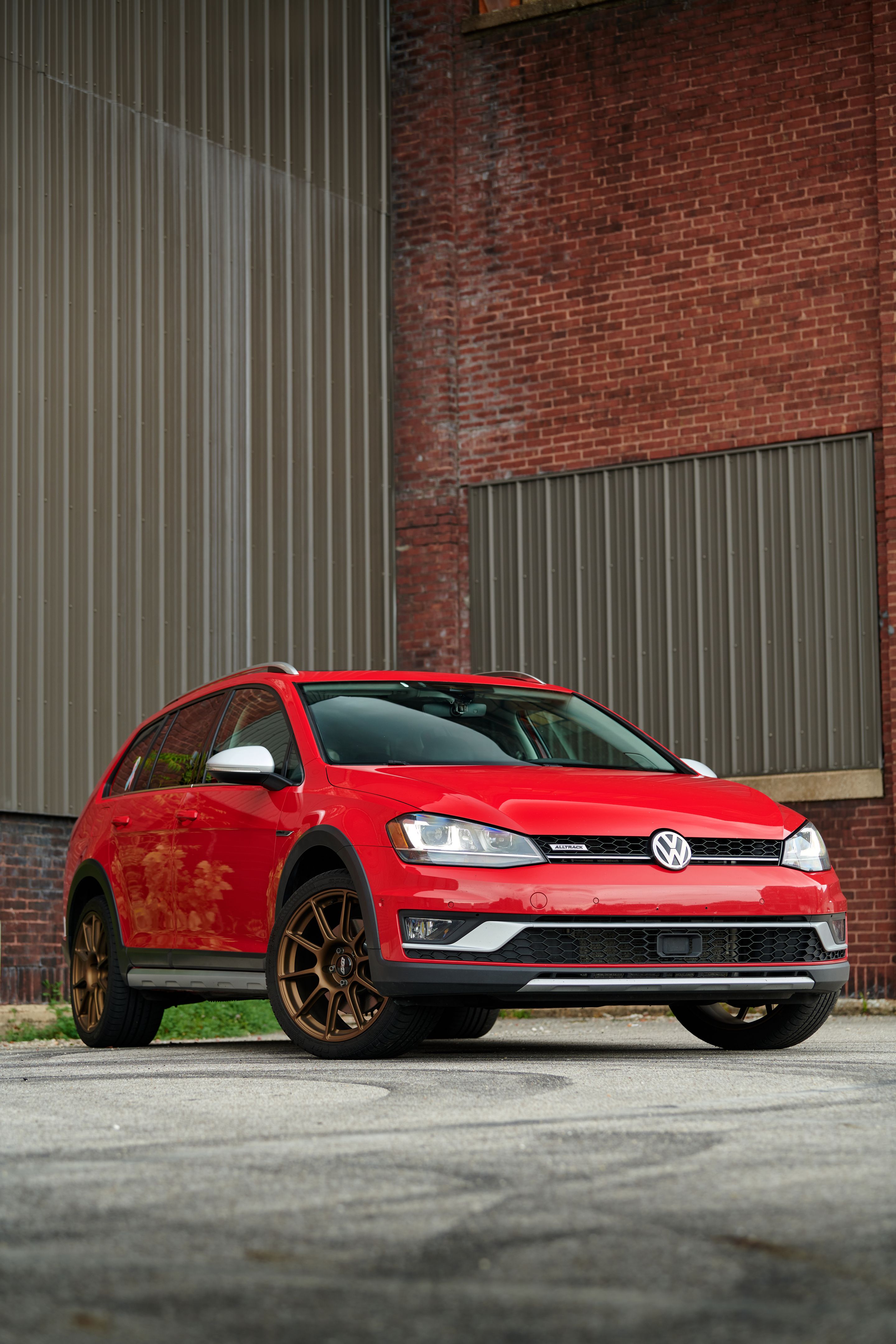 Red VW MK7 Alltrack/SportWagen Alltrack with 18" SM-10 Apex wheels in Satin Bronze