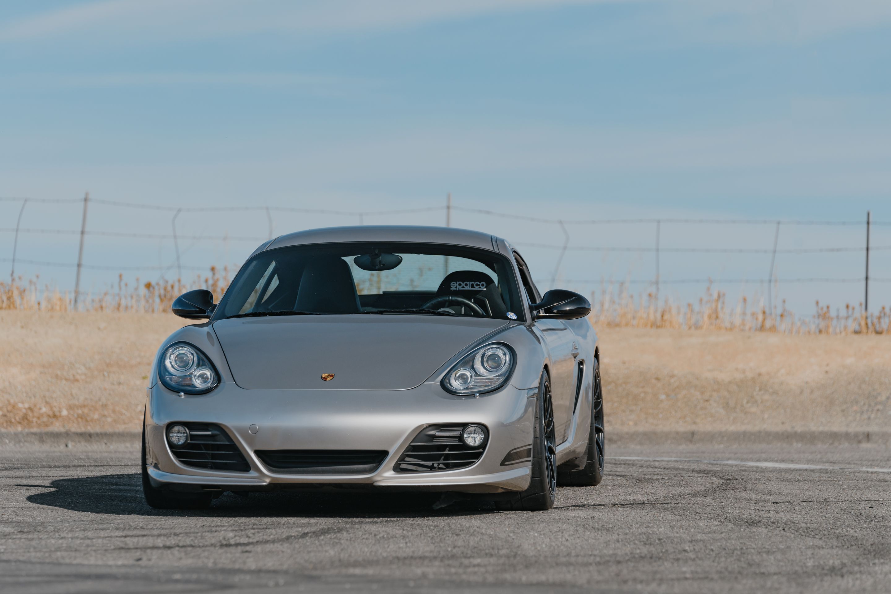 Silver Porsche 987 Cayman R with 18" SM-10RS Apex wheels in Satin Black