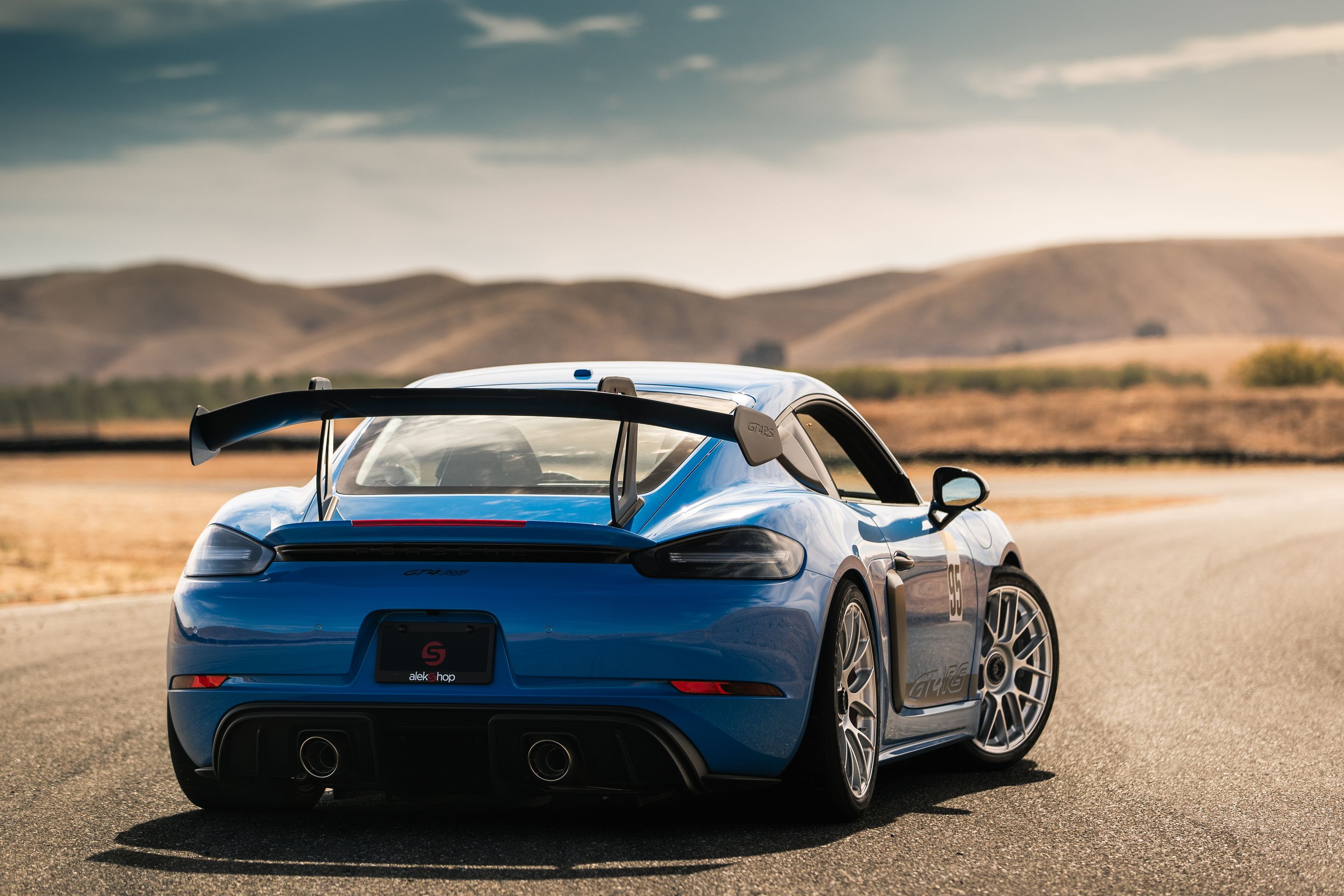 Blue Porsche 718 Cayman GT4 RS with 19" EC-7RS Apex wheels in Race Silver