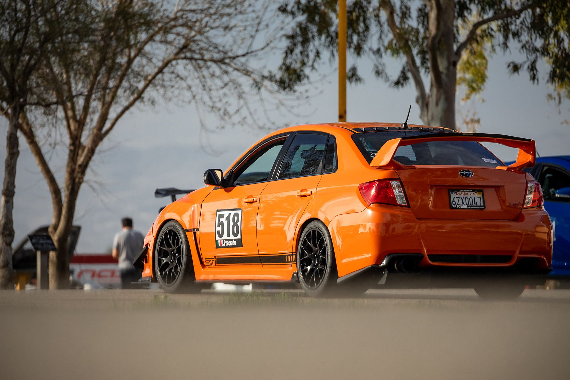 Orange Subaru GR WRX STI with 18" EC-7 Apex wheels in Satin Black
