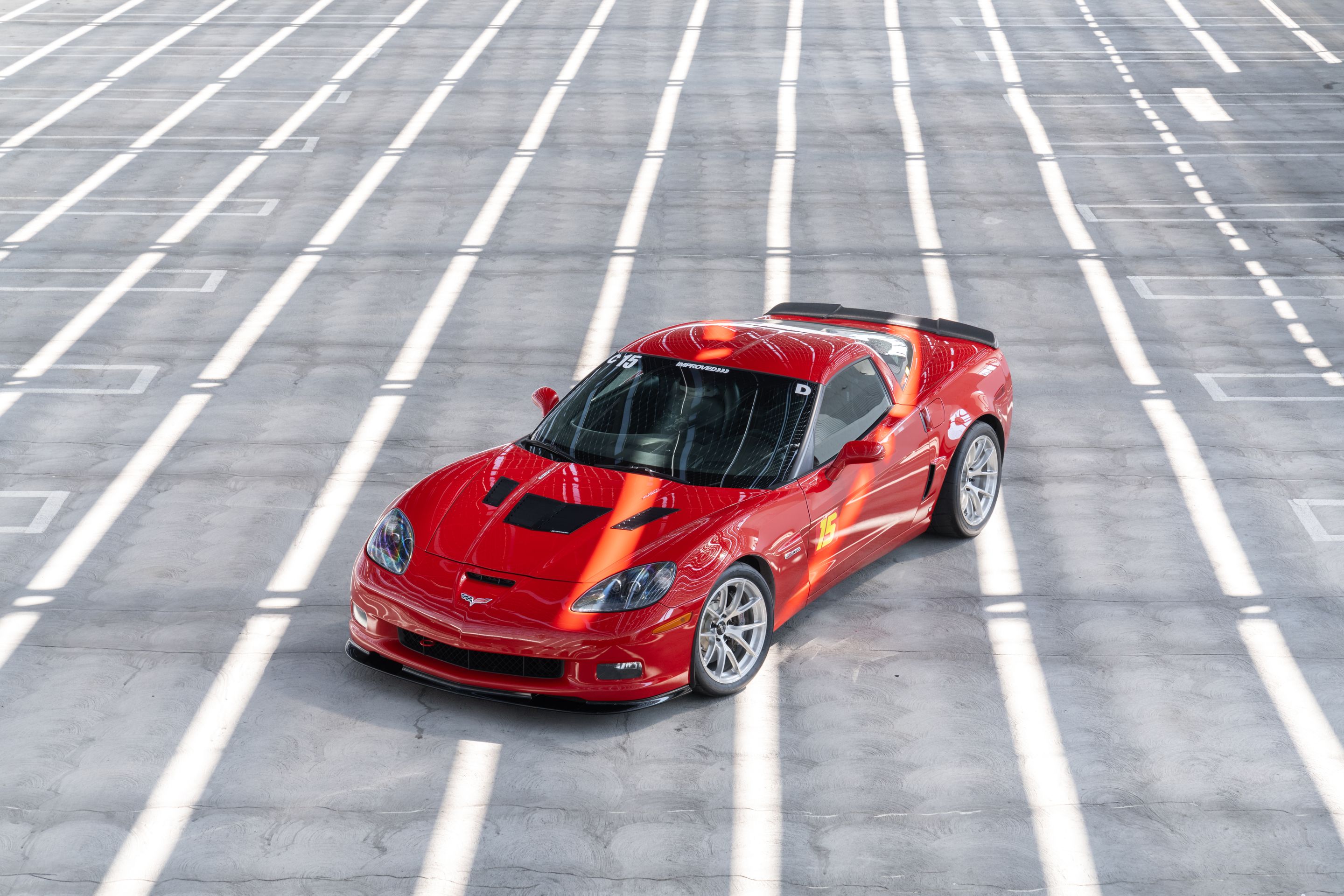 Red Chevrolet C6 Corvette Z06 with 18" VS-5RS Apex wheels in Brushed Clear