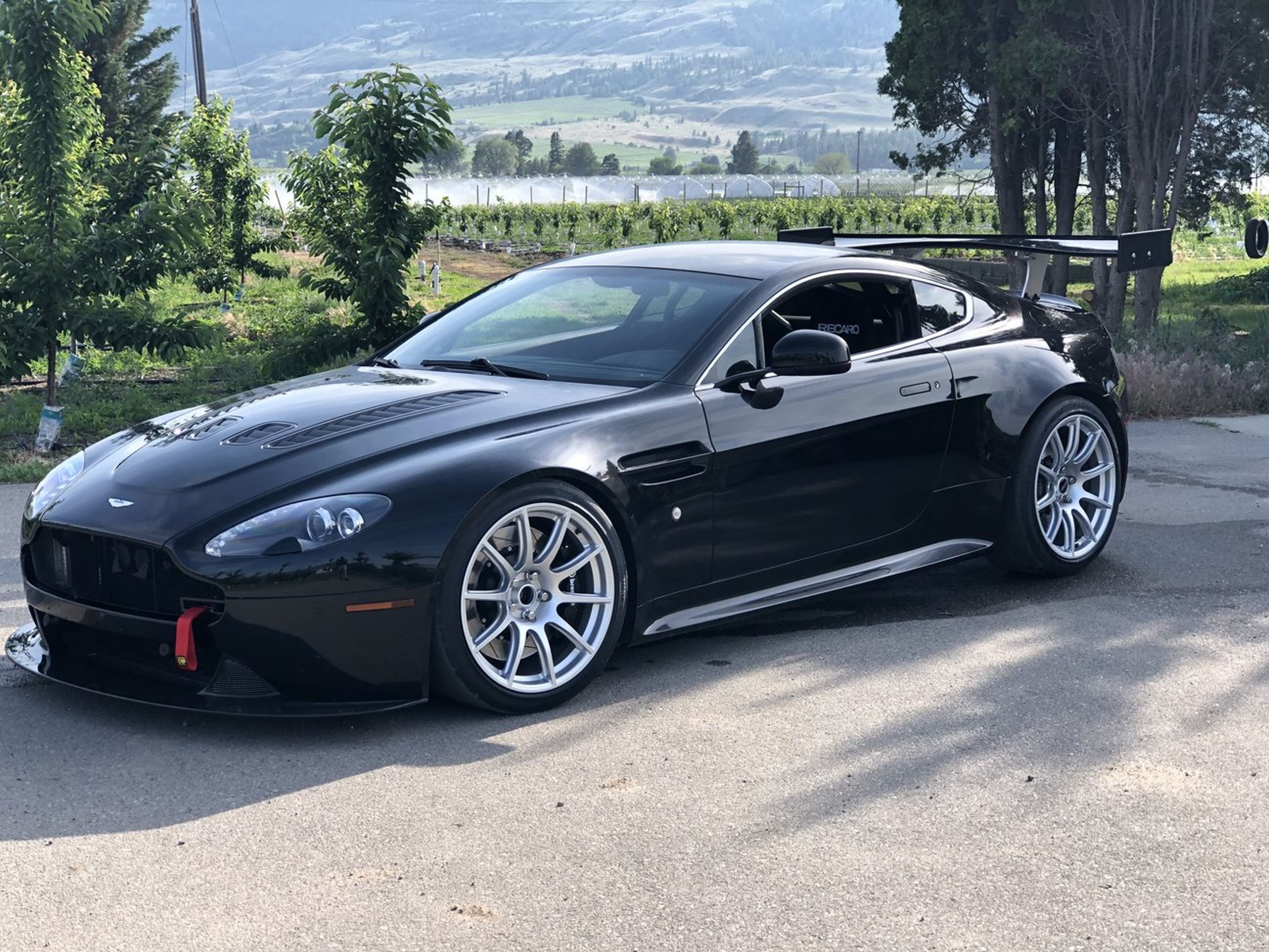 Black Aston Martin V8/V12 Vantage with 19" SM-10 Apex wheels in Race Silver