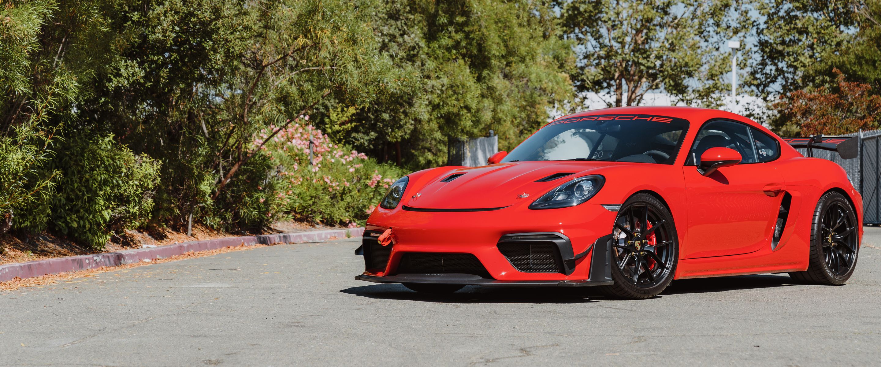 Red Porsche 718 Cayman GT4 with 19" VS-5RS Apex wheels in Satin Black