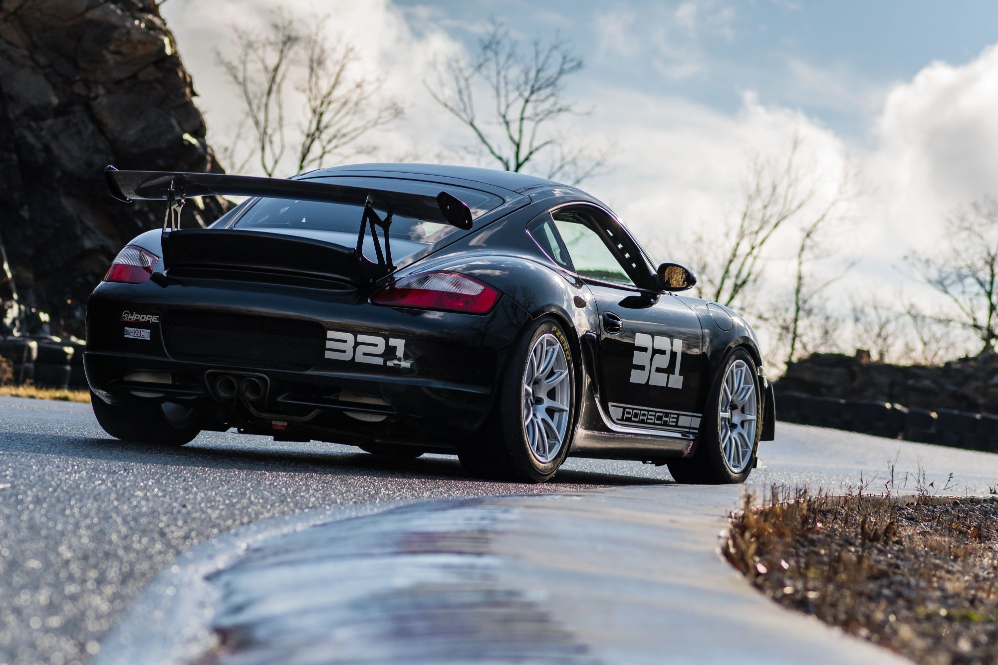 Black Porsche 987 Cayman S with 18" SM-10 Apex wheels in Race Silver