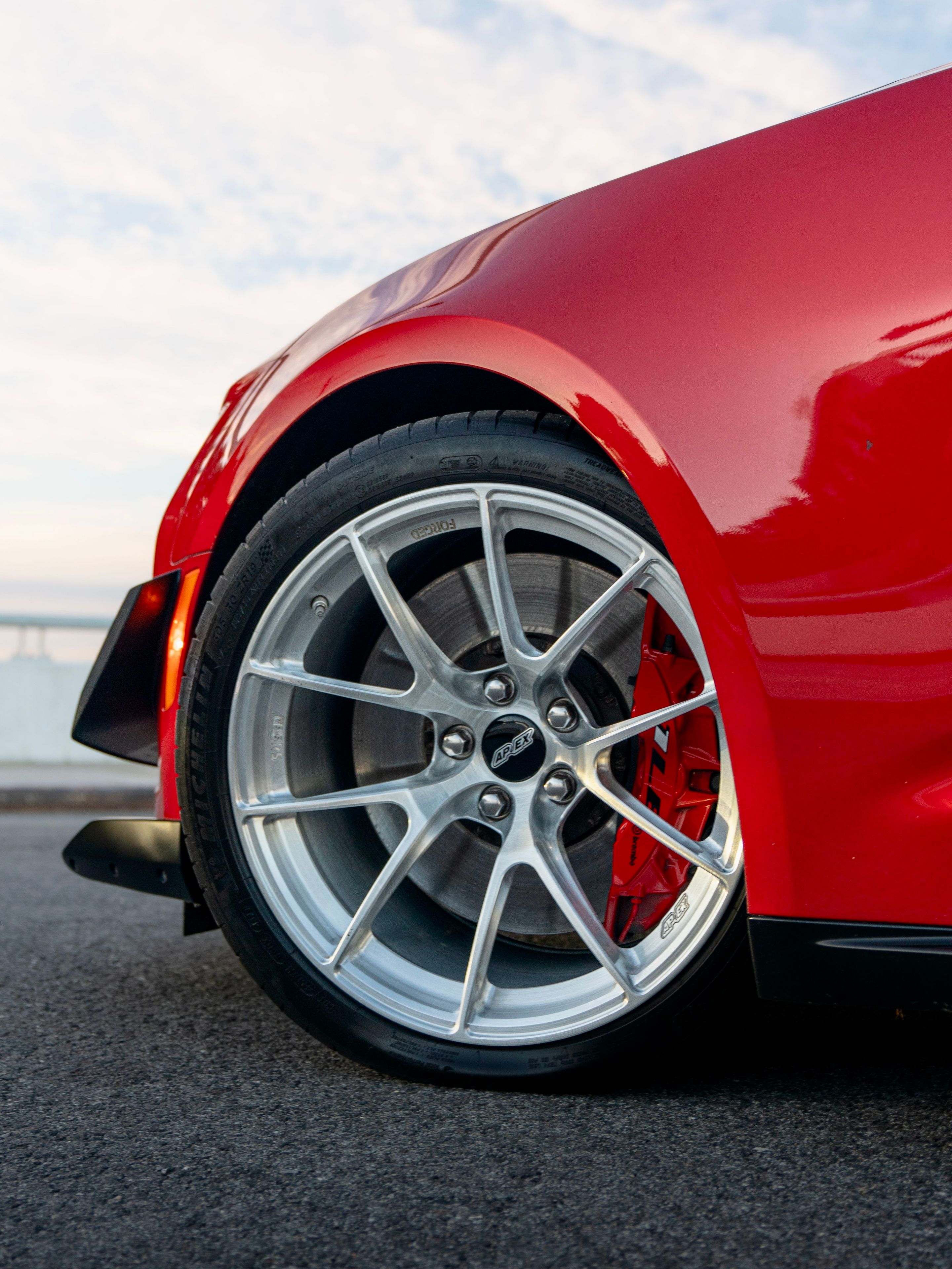 Red Chevrolet 6th Gen Camaro ZL1 1LE with 19" VS-5RS Apex wheels in Brushed Clear