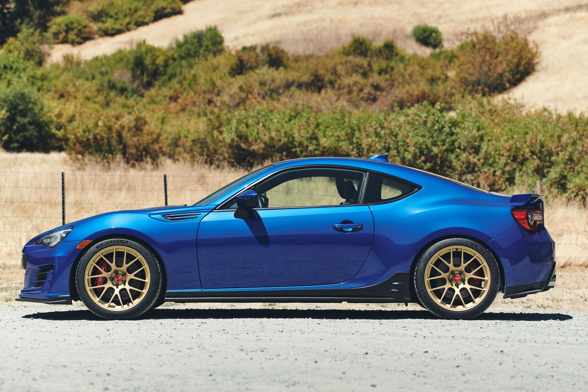Blue Subaru ZC6 / Gen 1 BRZ with 18" EC-7R Apex wheels in Satin Gold