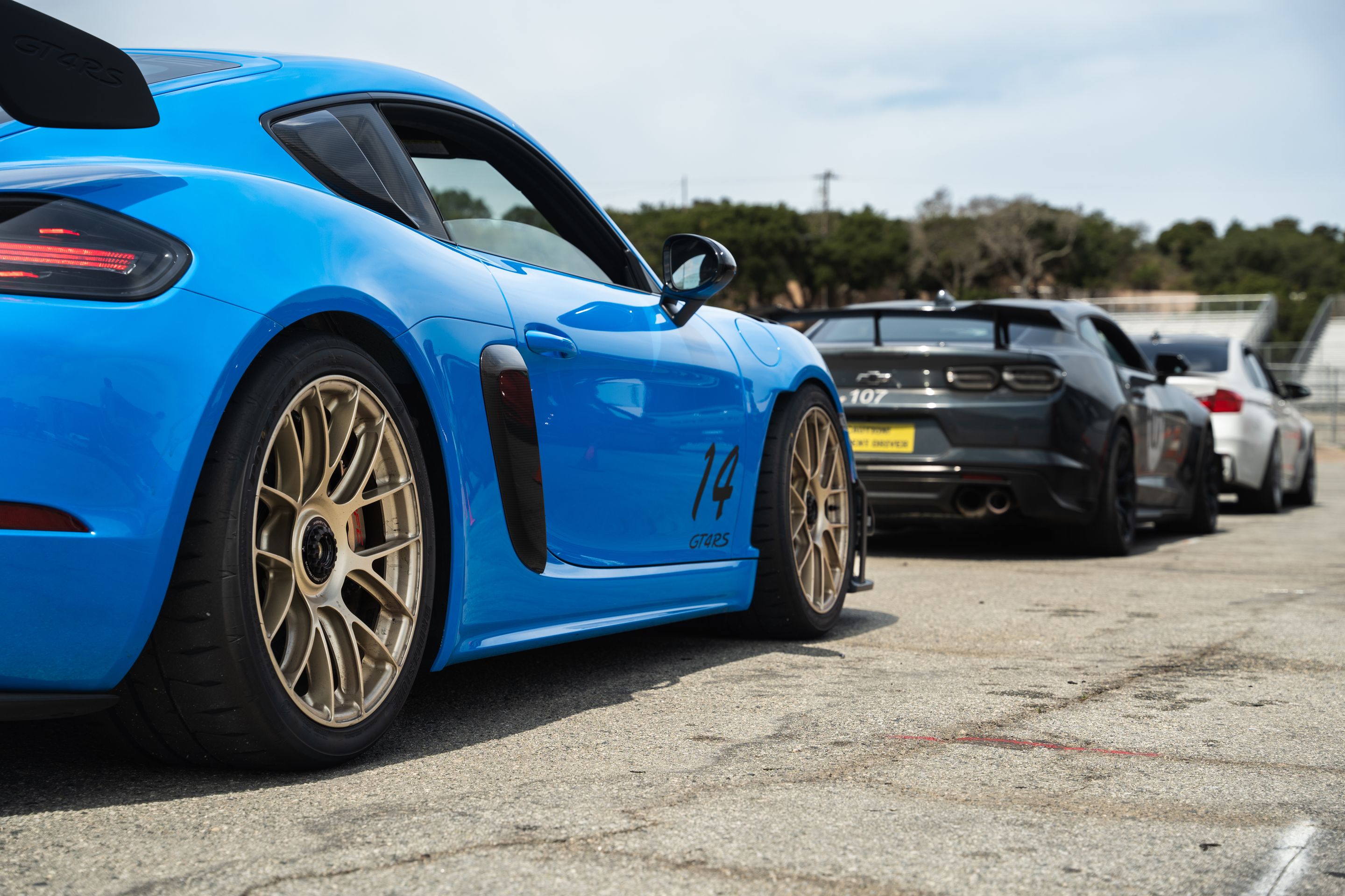 Blue Porsche 718 Cayman GT4 RS with 19" EC-7RS Apex wheels in Motorsport Gold