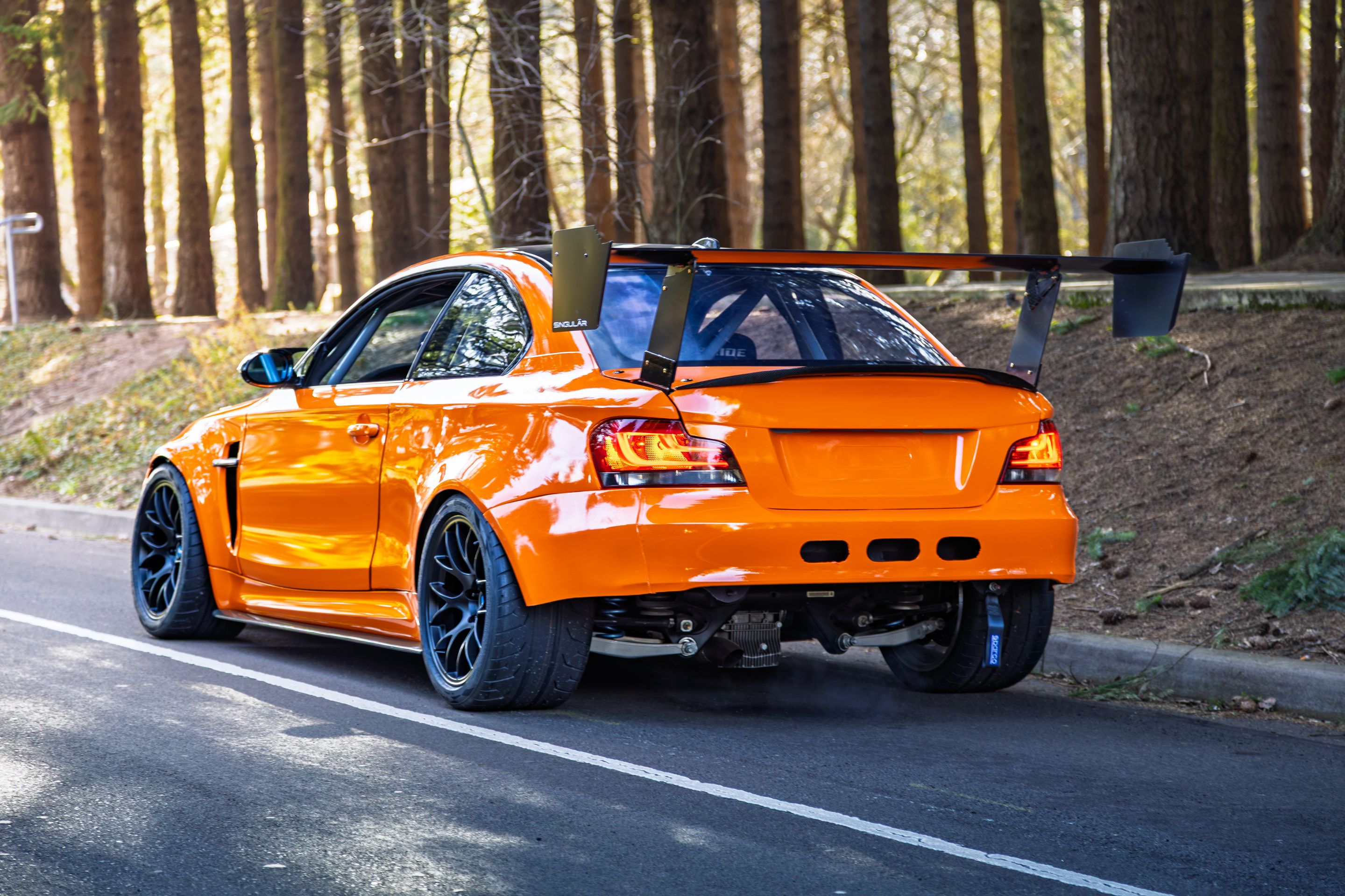 Orange BMW E82 1M with 18" EC-7 Apex wheels in Satin Black