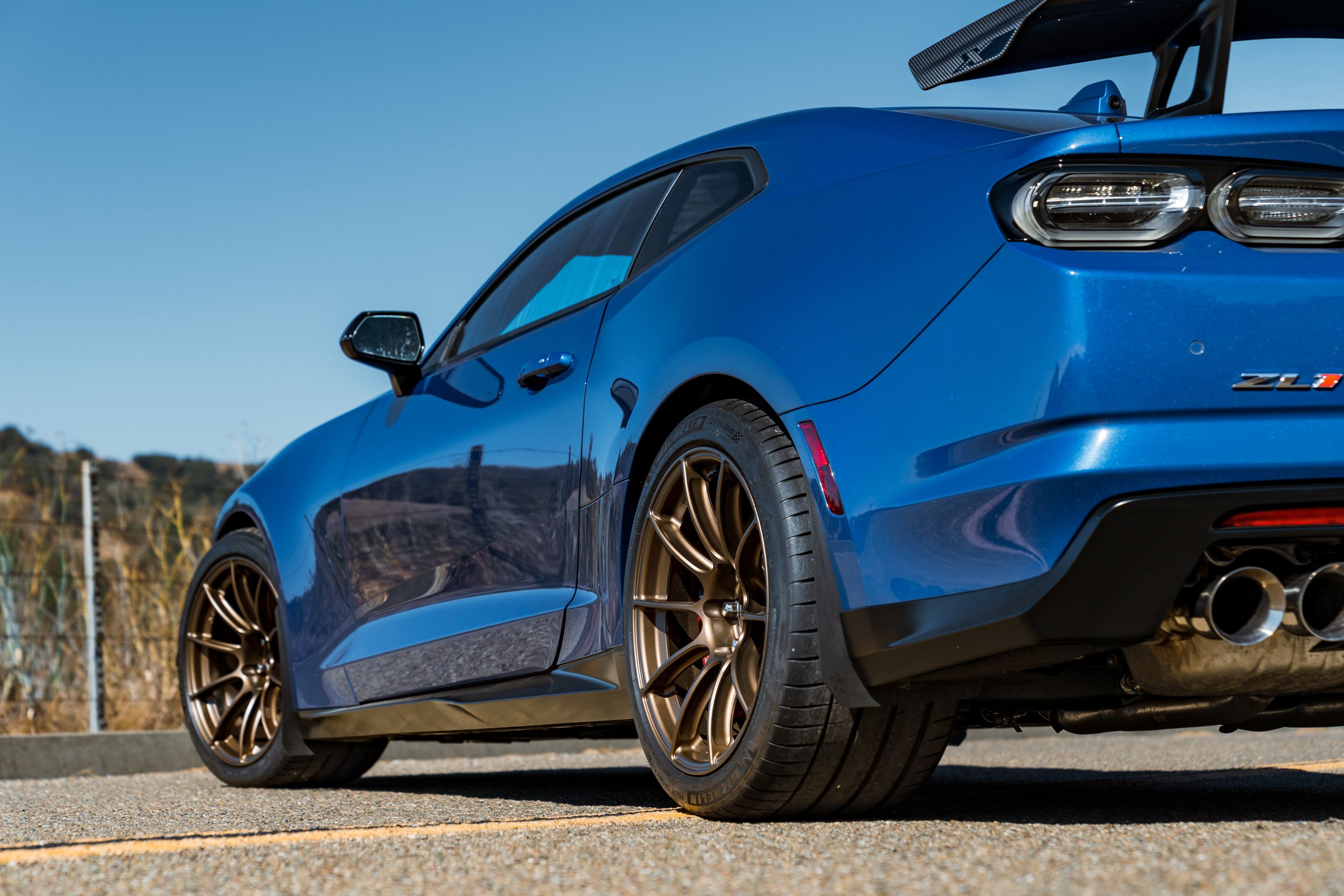 Blue Chevrolet 6th Gen Camaro ZL1 1LE with 19" SM-10RS Apex wheels in Satin Bronze