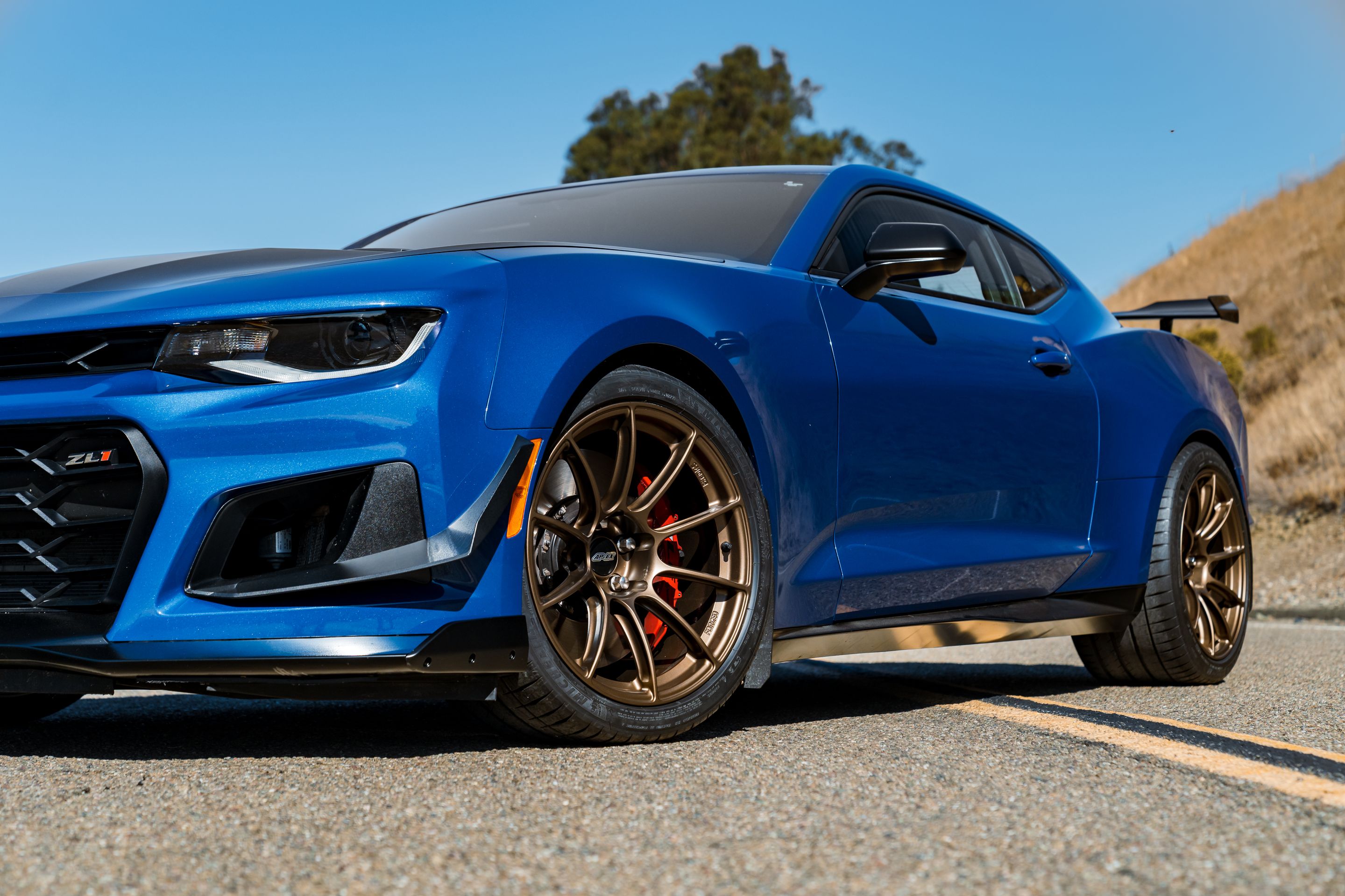 Blue Chevrolet 6th Gen Camaro ZL1 1LE with 19" SM-10RS Apex wheels in Satin Bronze