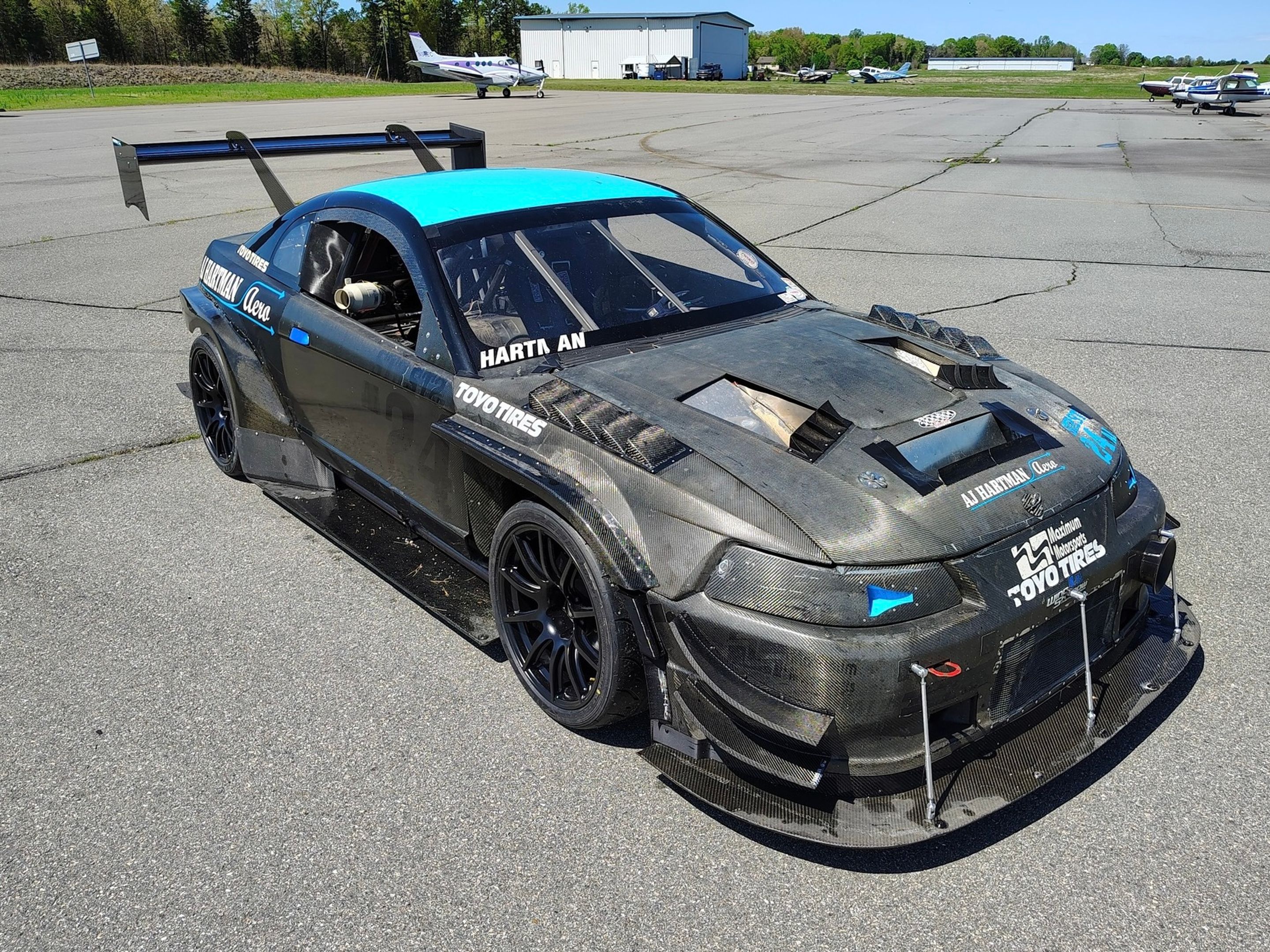 Black Ford SN95 Mustang V6 with 19" SM-10 Apex wheels in Satin Black