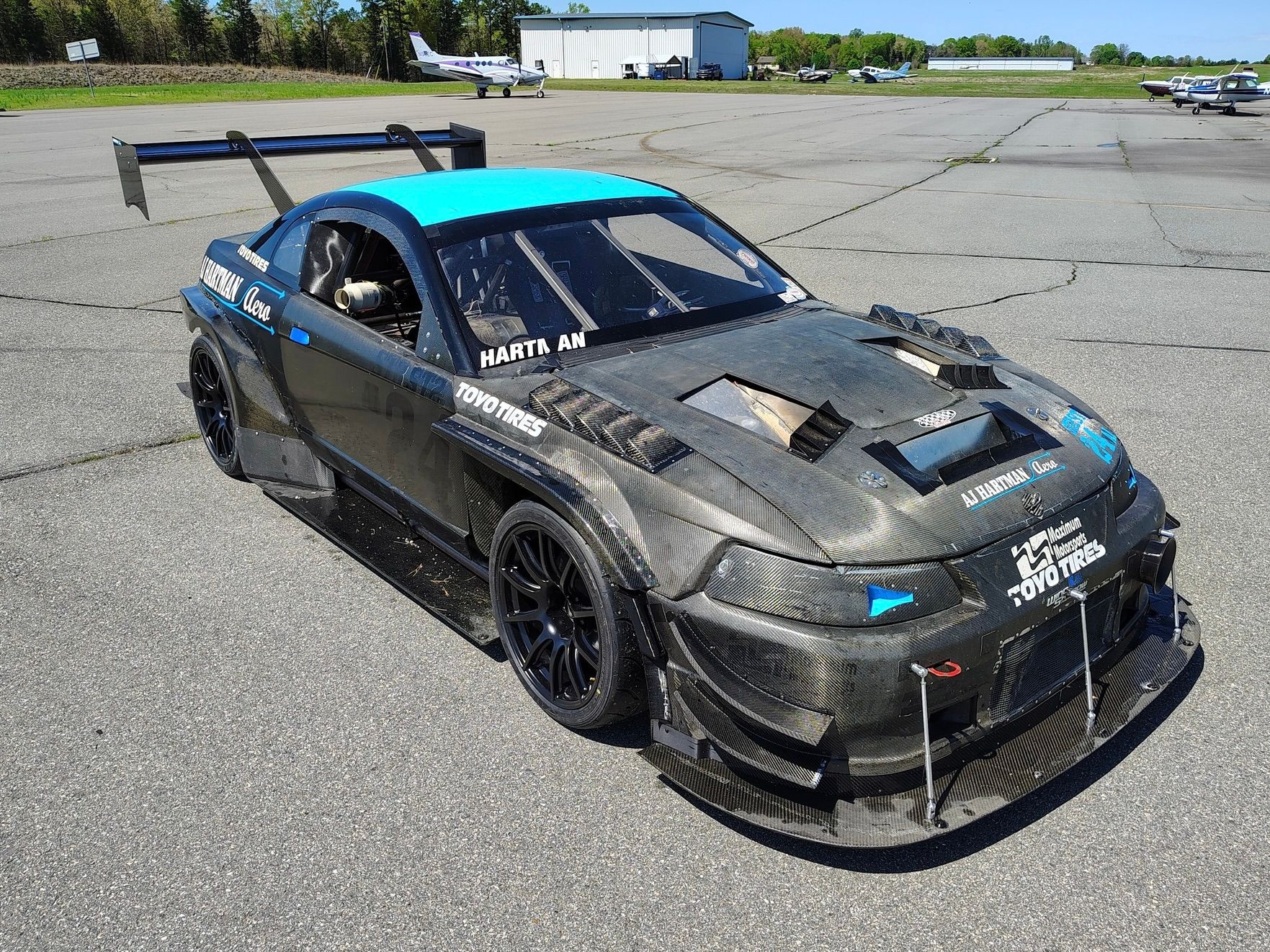 Black Ford SN95 Mustang V6 with 19" SM-10 Apex wheels in Satin Black