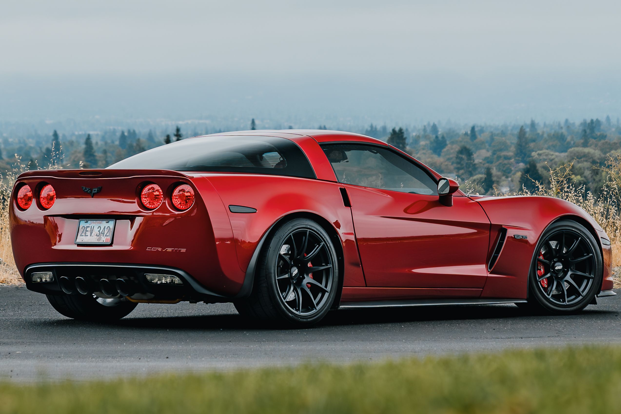 Red Chevrolet C6 Corvette Z06 with 18"/19" SM-10 Apex wheels in Satin Black