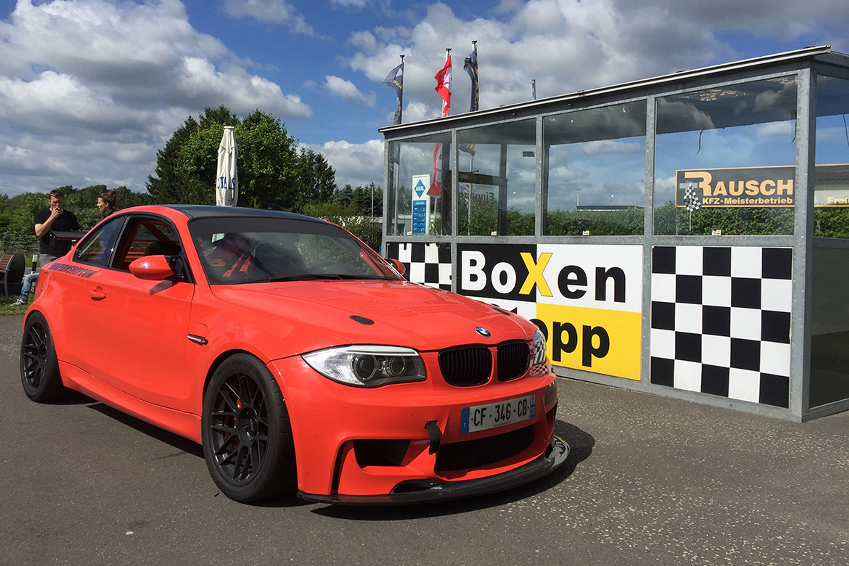 Orange BMW E82 1M with 18" ARC-8 Apex wheels in Satin Black