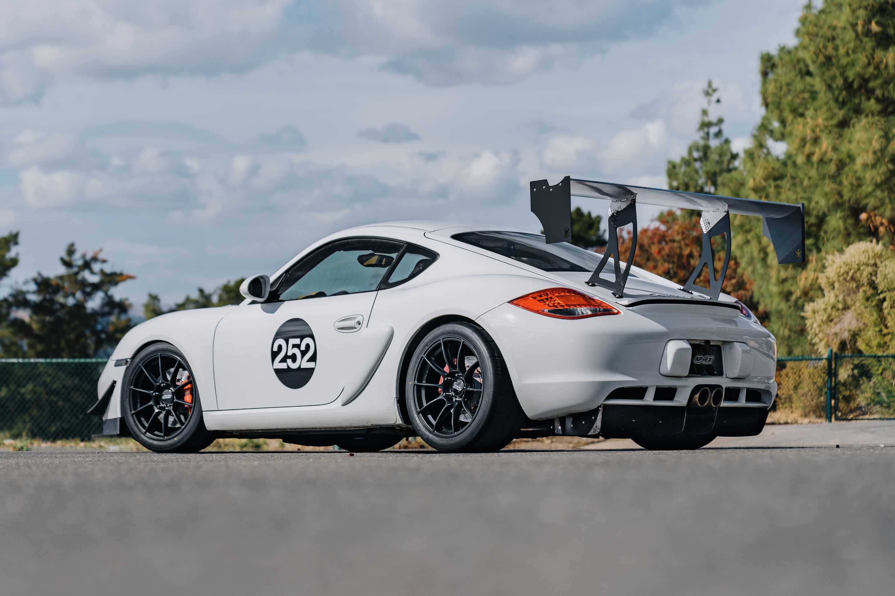 White Porsche 987 Cayman S with 18" SM-10RS Apex wheels in Satin Black