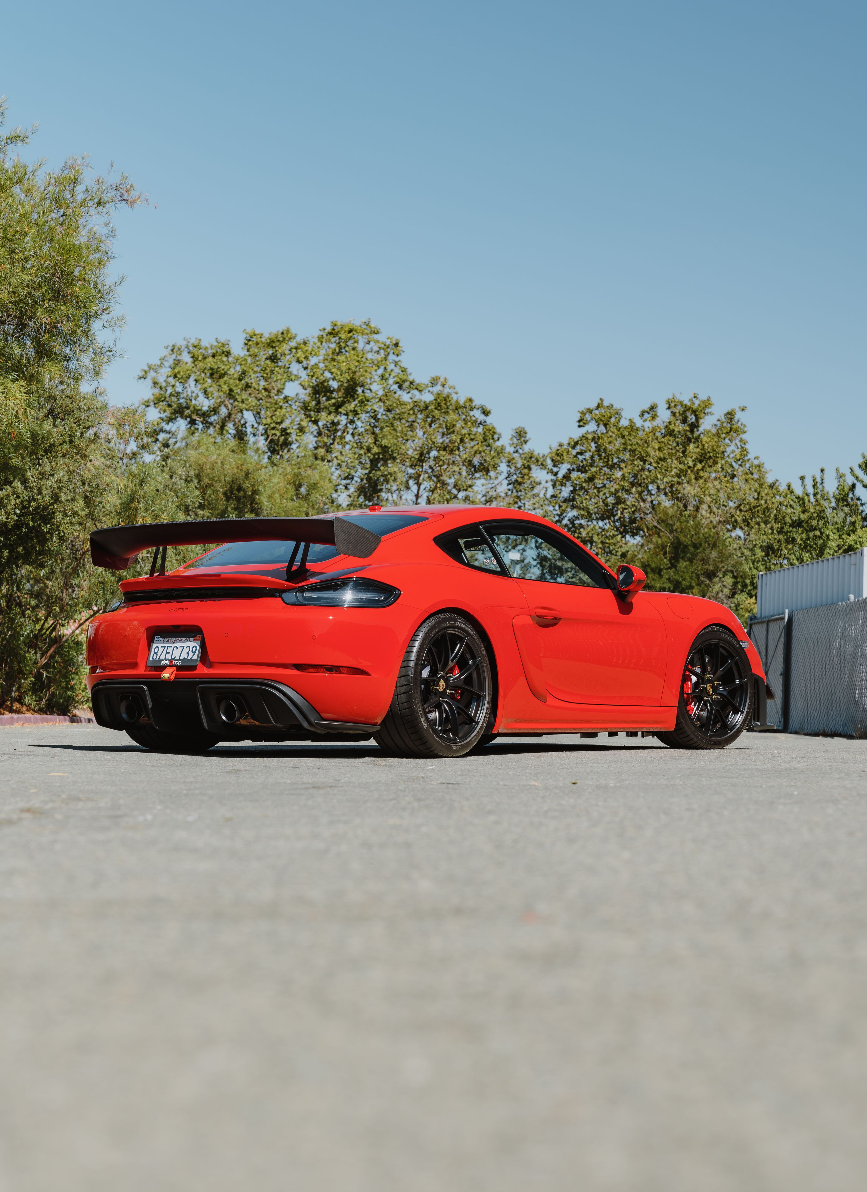 Red Porsche 718 Cayman GT4 with 19" VS-5RS Apex wheels in Satin Black
