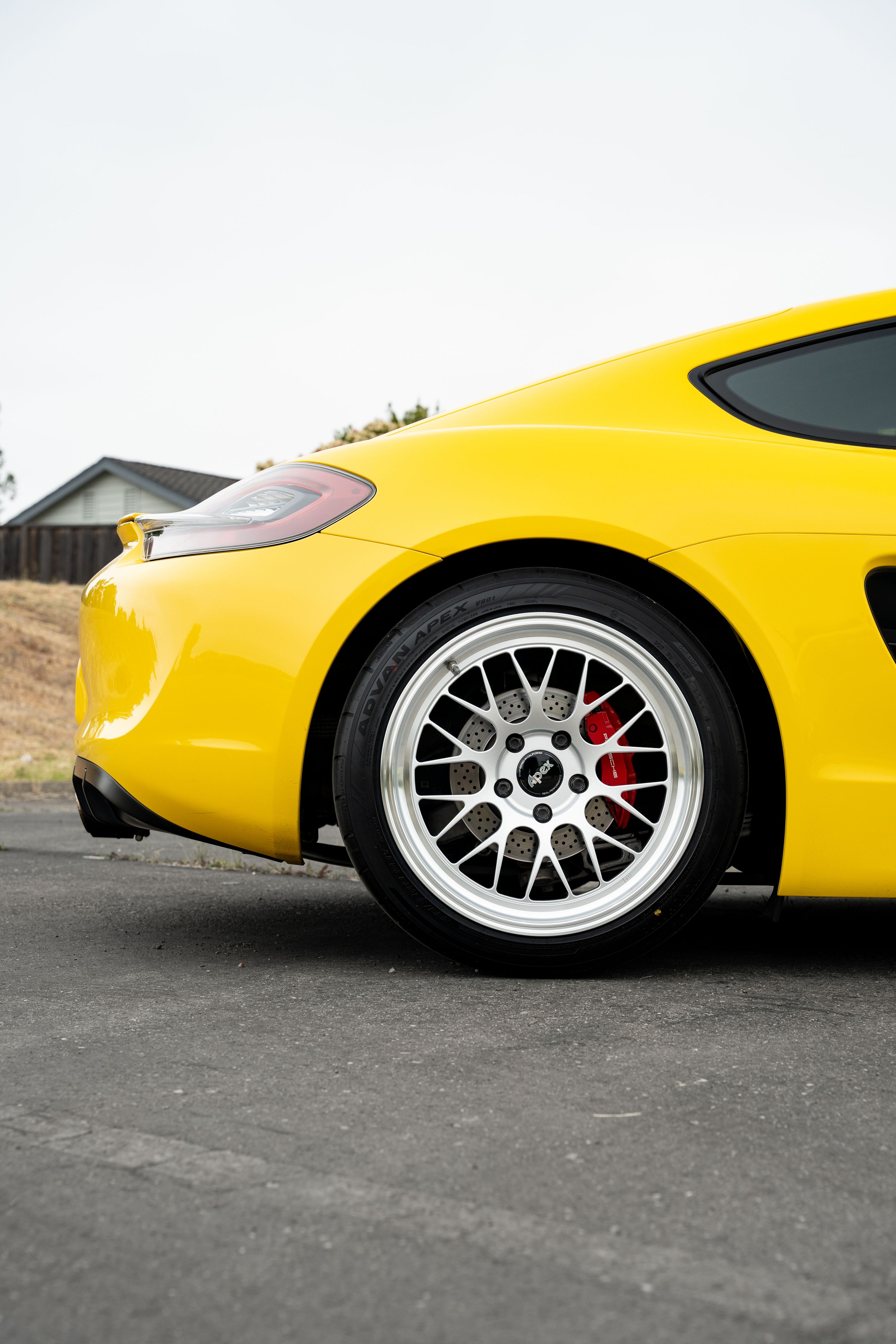 Yellow Porsche 981 Cayman GTS with 19" ML-10RT Apex wheels in Machined Lip Race Silver
