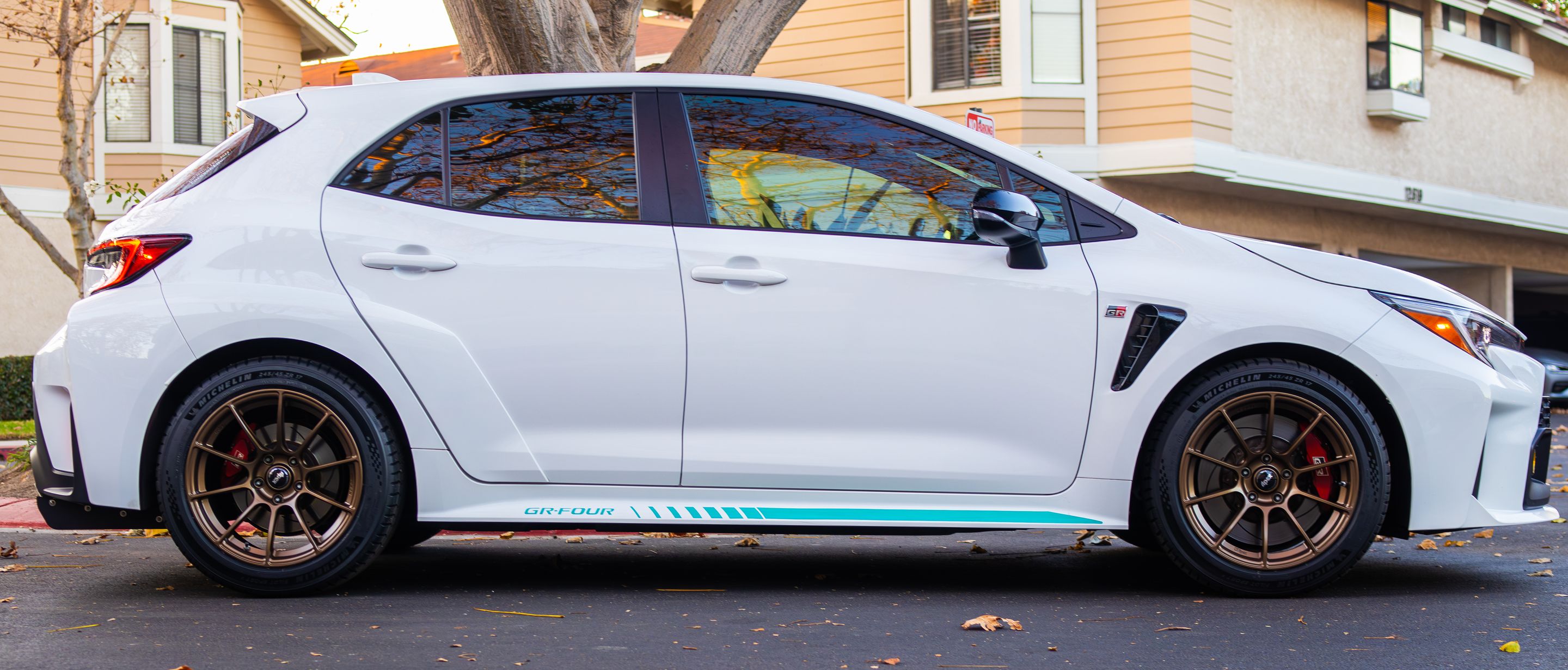 White Toyota GR Corolla with 17" SM-10RS Apex wheels in Satin Bronze