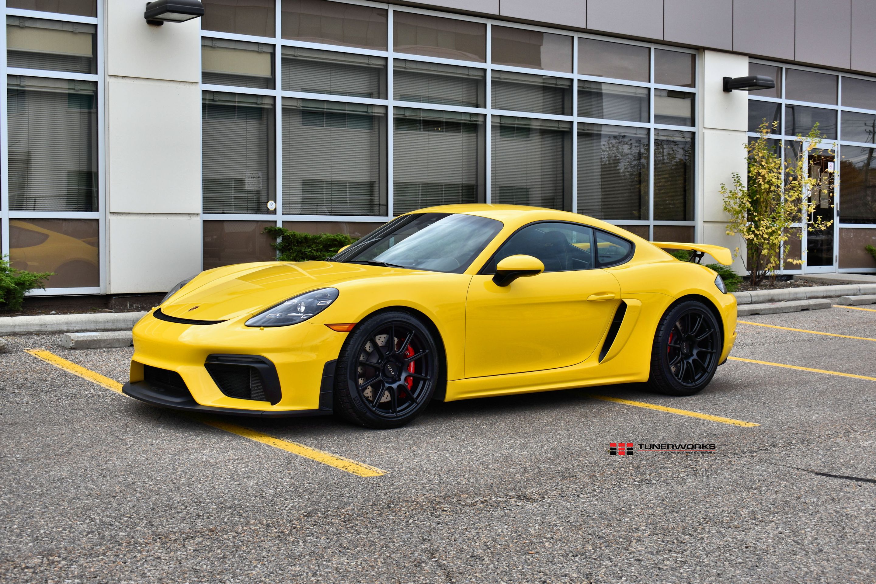 Yellow Porsche 718 Cayman GT4 with 19" SM-10 Apex wheels in Satin Black