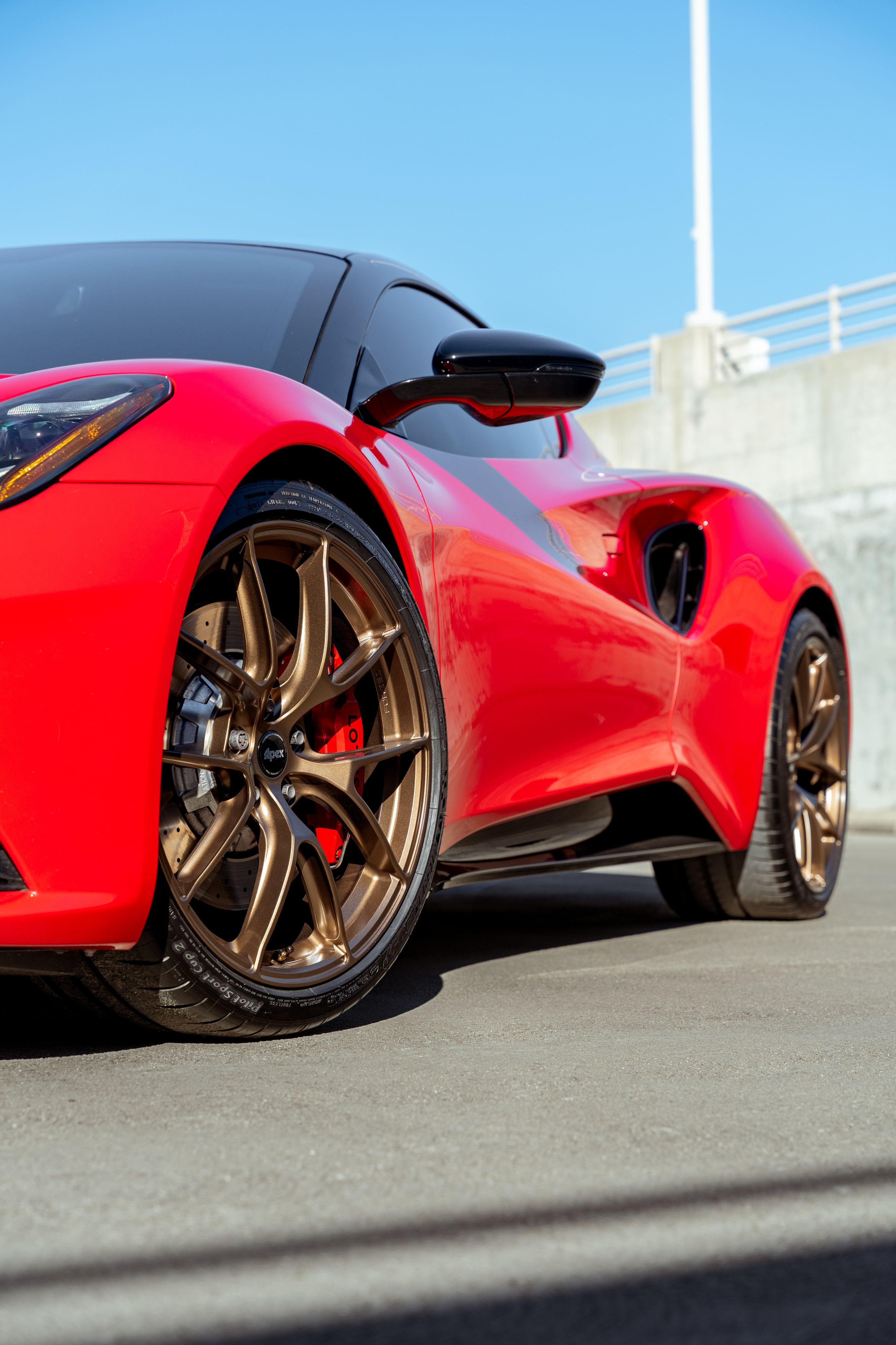 Red Lotus Emira with 20" VS-5RS Apex wheels in Anthracite