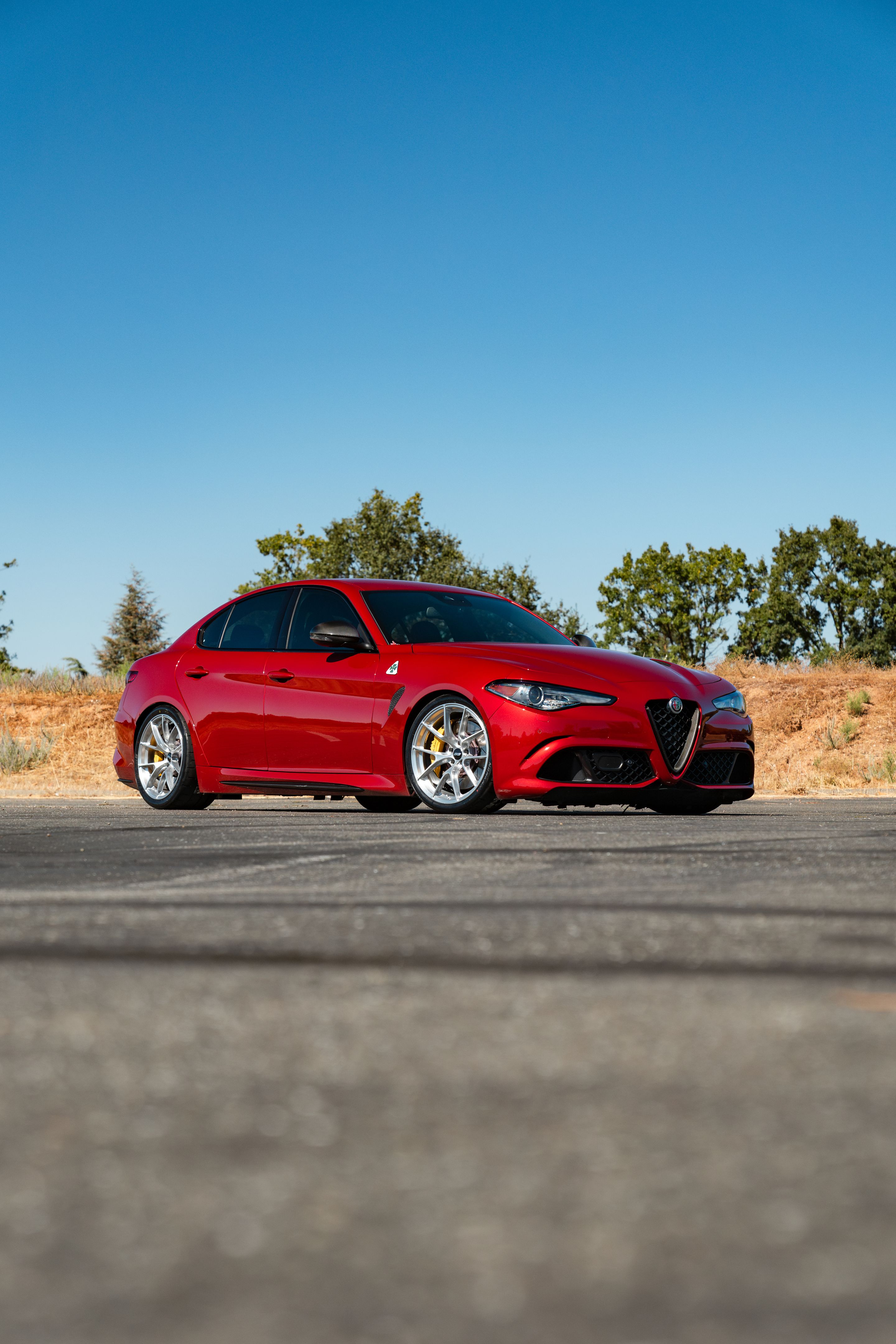 Red Alfa Romeo Giulia Quadrifoglio with 19" VS-5RS Apex wheels in Brushed Clear
