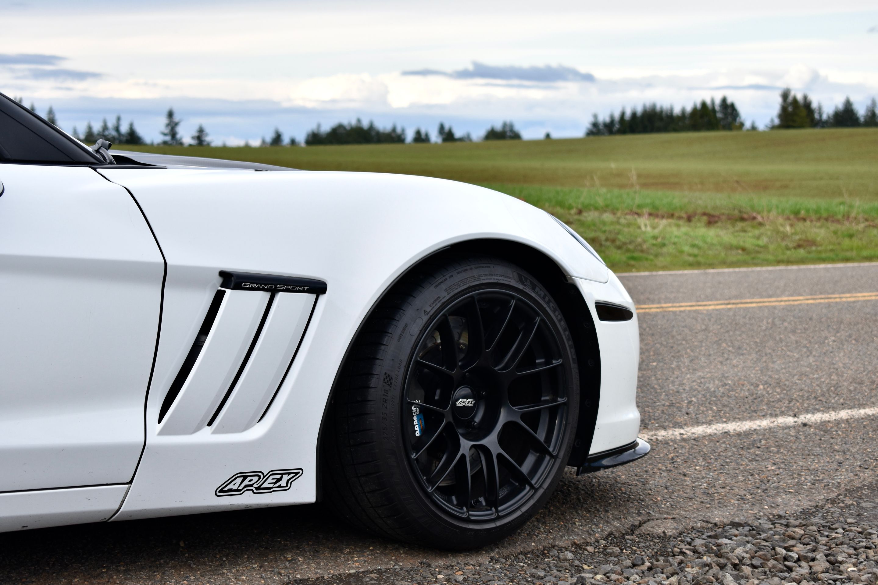 White Chevrolet C6 Corvette Grand Sport with 18"/19" EC-7RS Apex wheels in Satin Black