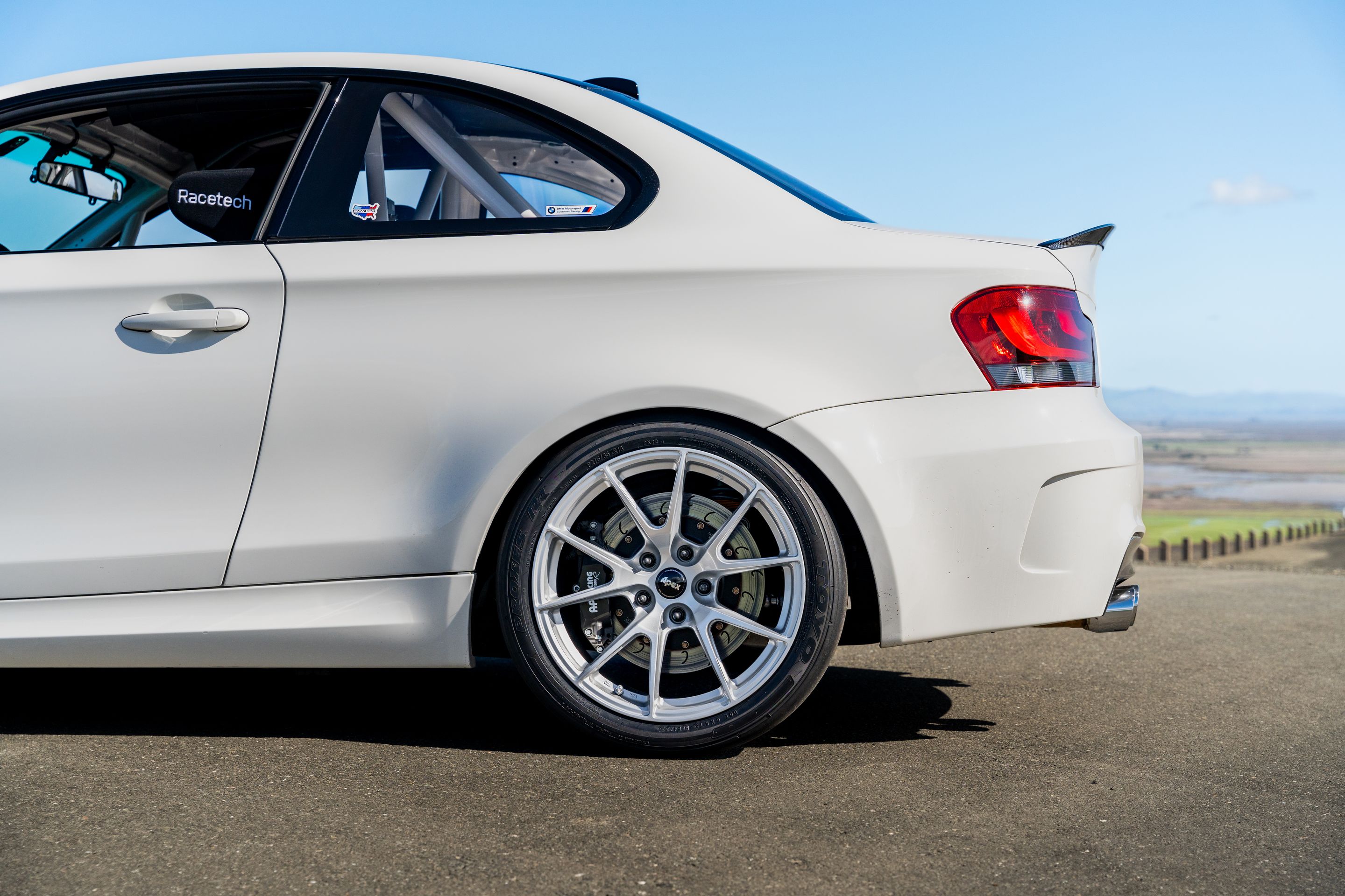 White BMW E82 1M with 18" VS-5 Apex wheels in Race Silver