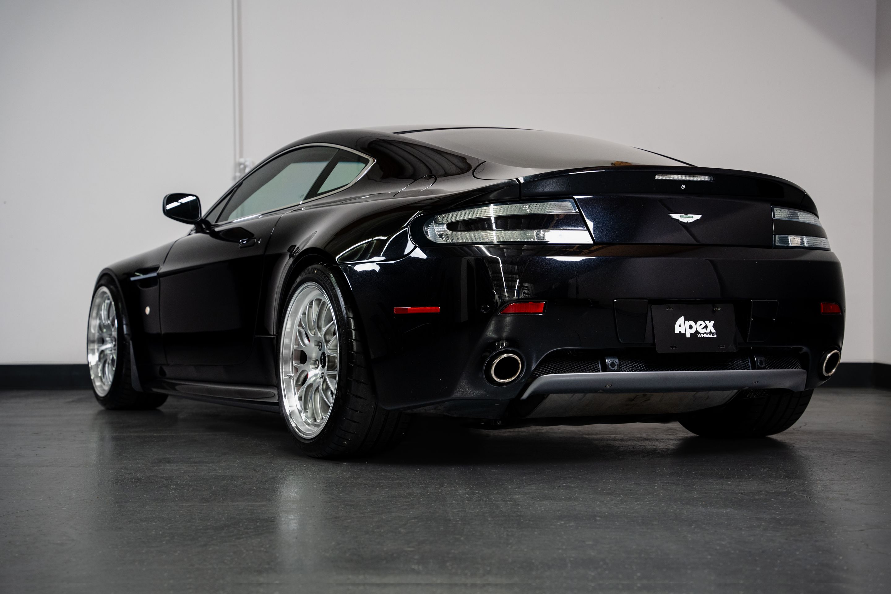 Black Aston Martin V8/V12 Vantage with 19" ML-10RT Apex wheels in Machined Lip Brushed Clear