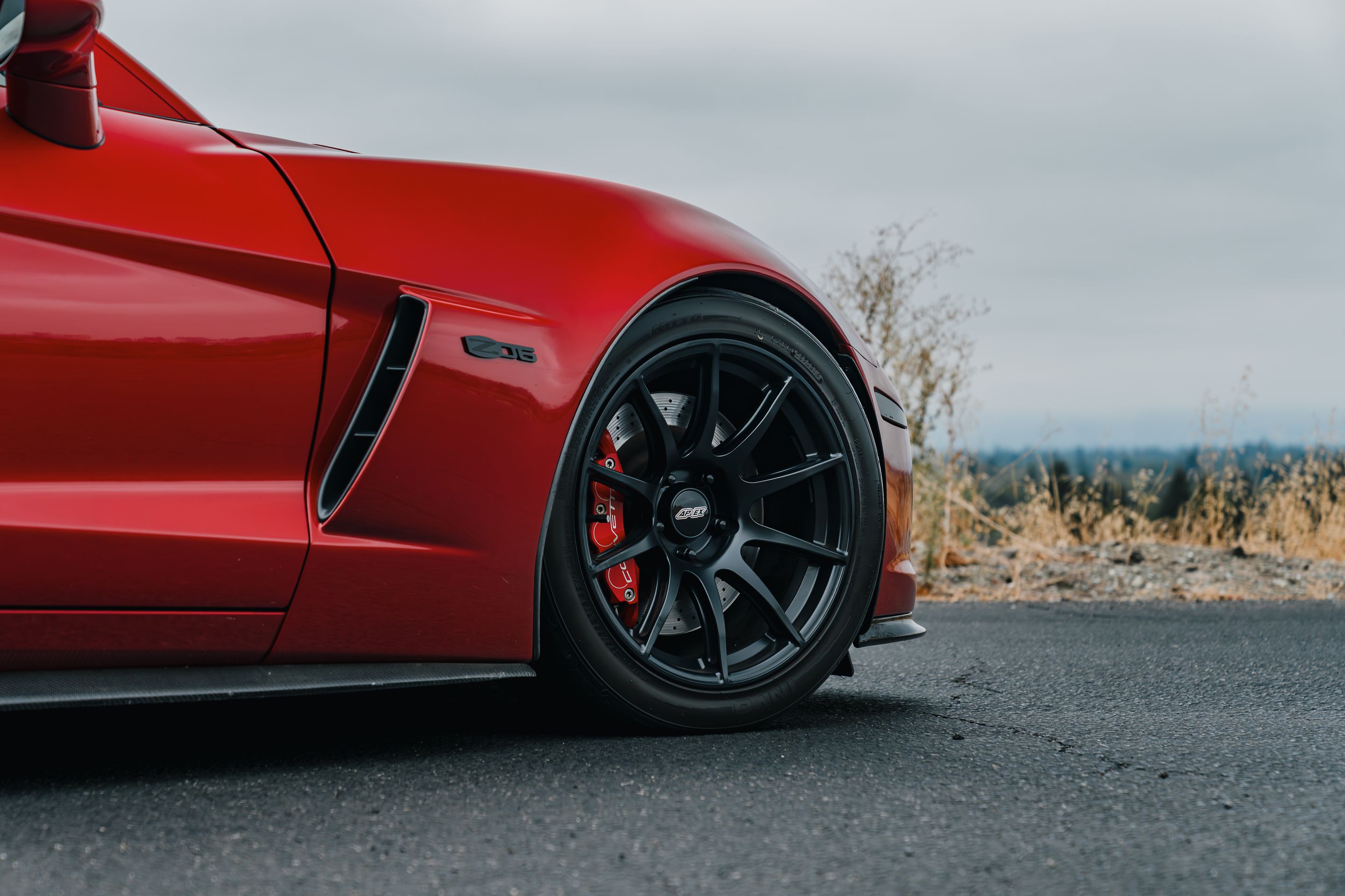 Red Chevrolet C6 Corvette Z06 with 18"/19" SM-10 Apex wheels in Satin Black