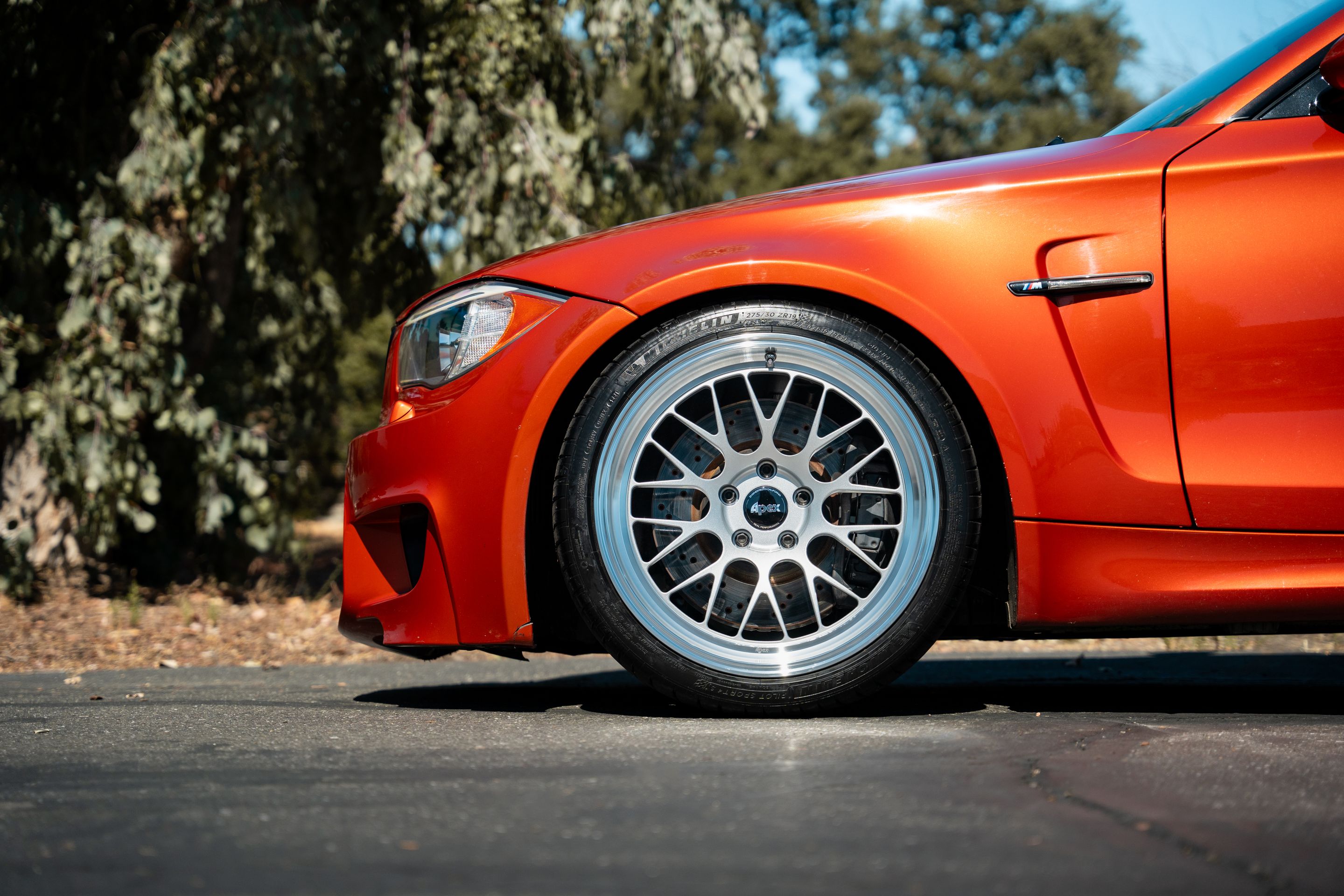 Orange BMW E82 1M with 19" ML-10RT Apex wheels in Machined Lip Race Silver