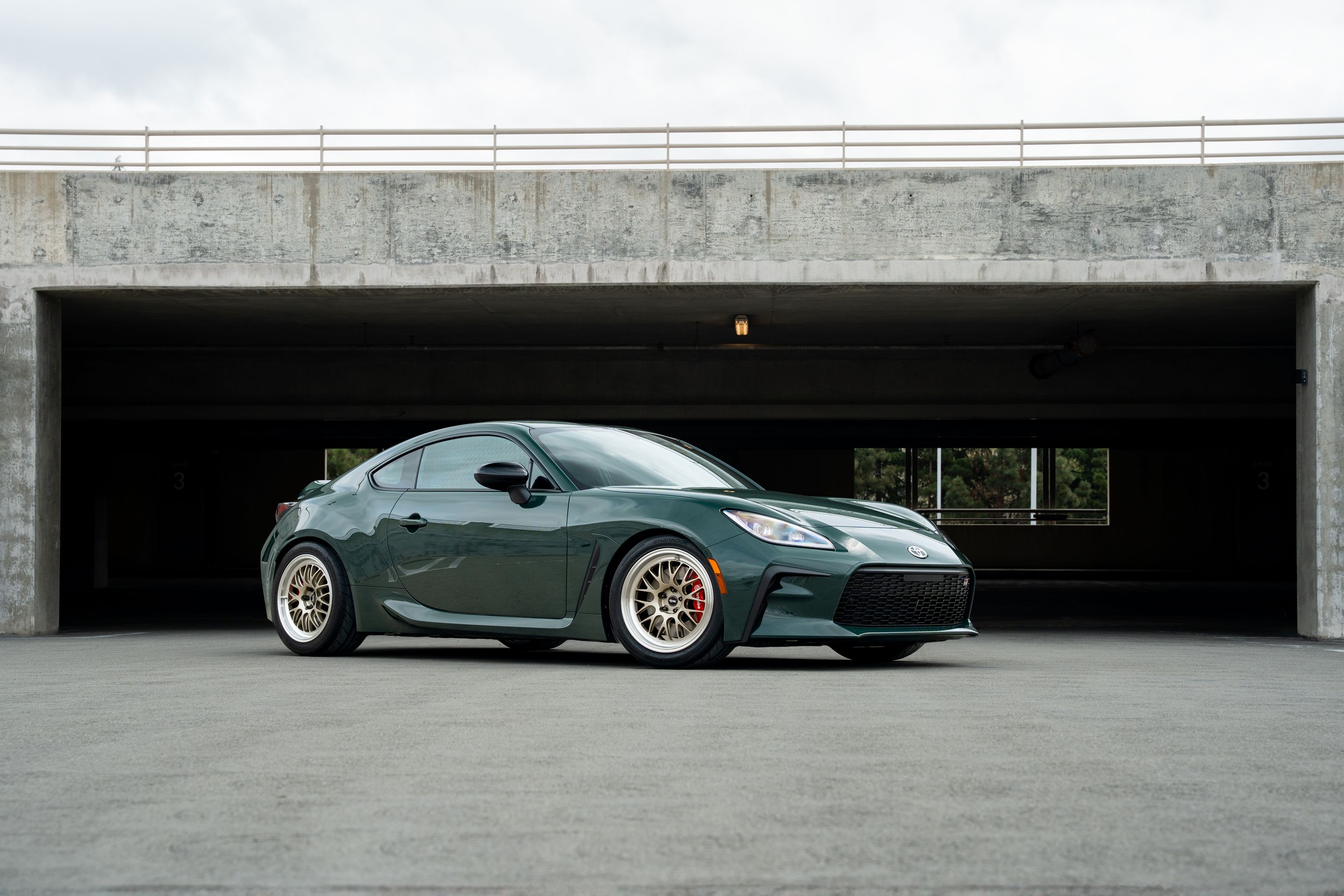 Green Toyota GR86 with 17" ML-10RT Apex wheels in Machined Lip Gloss Motorsport Gold