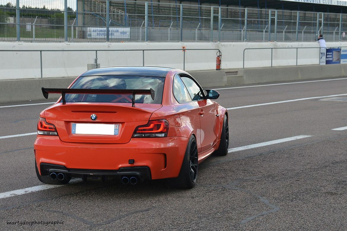 Orange BMW E82 1M with 18" EC-7 Apex wheels in Satin Black