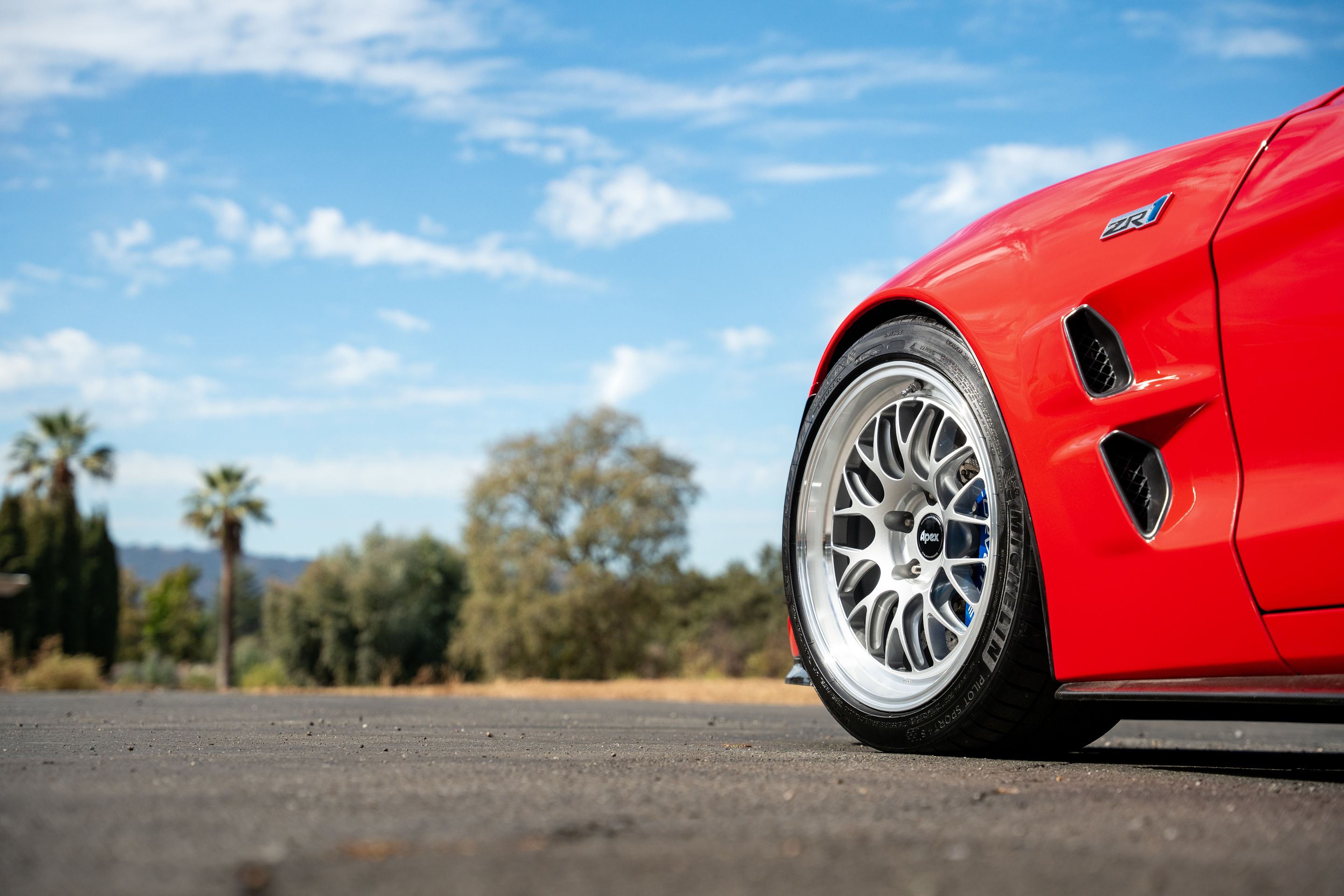 Red Chevrolet C6 Corvette ZR-1 with 18"/19" ML-10RT Apex wheels in Machined Lip Race Silver