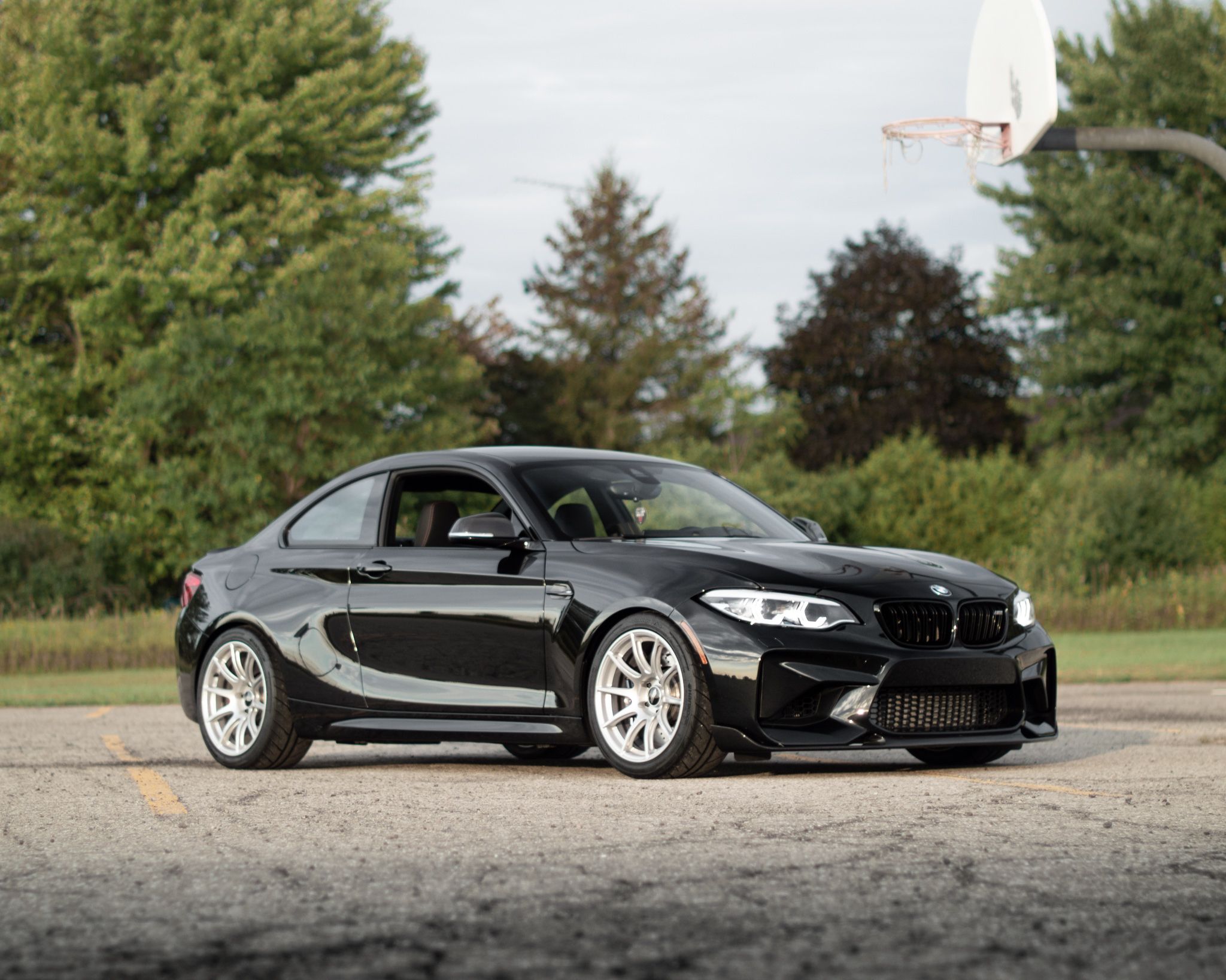 Black BMW F87 M2 with 18" SM-10 Apex wheels in Race Silver