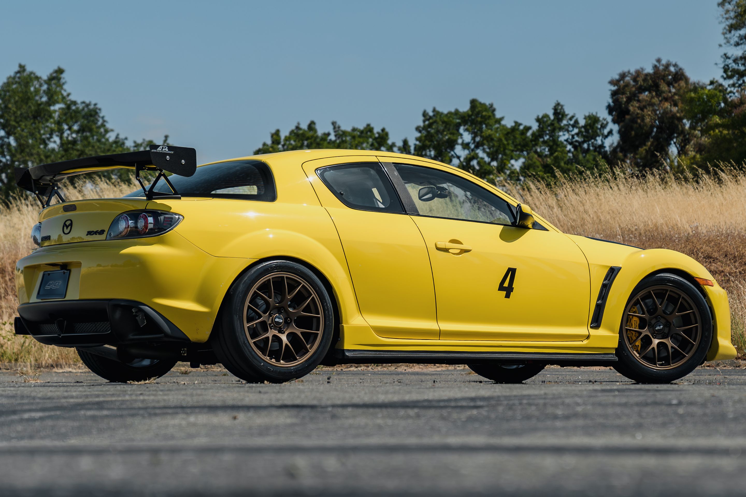 Yellow Mazda RX-8 with 18" EC-7 Apex wheels in Satin Bronze