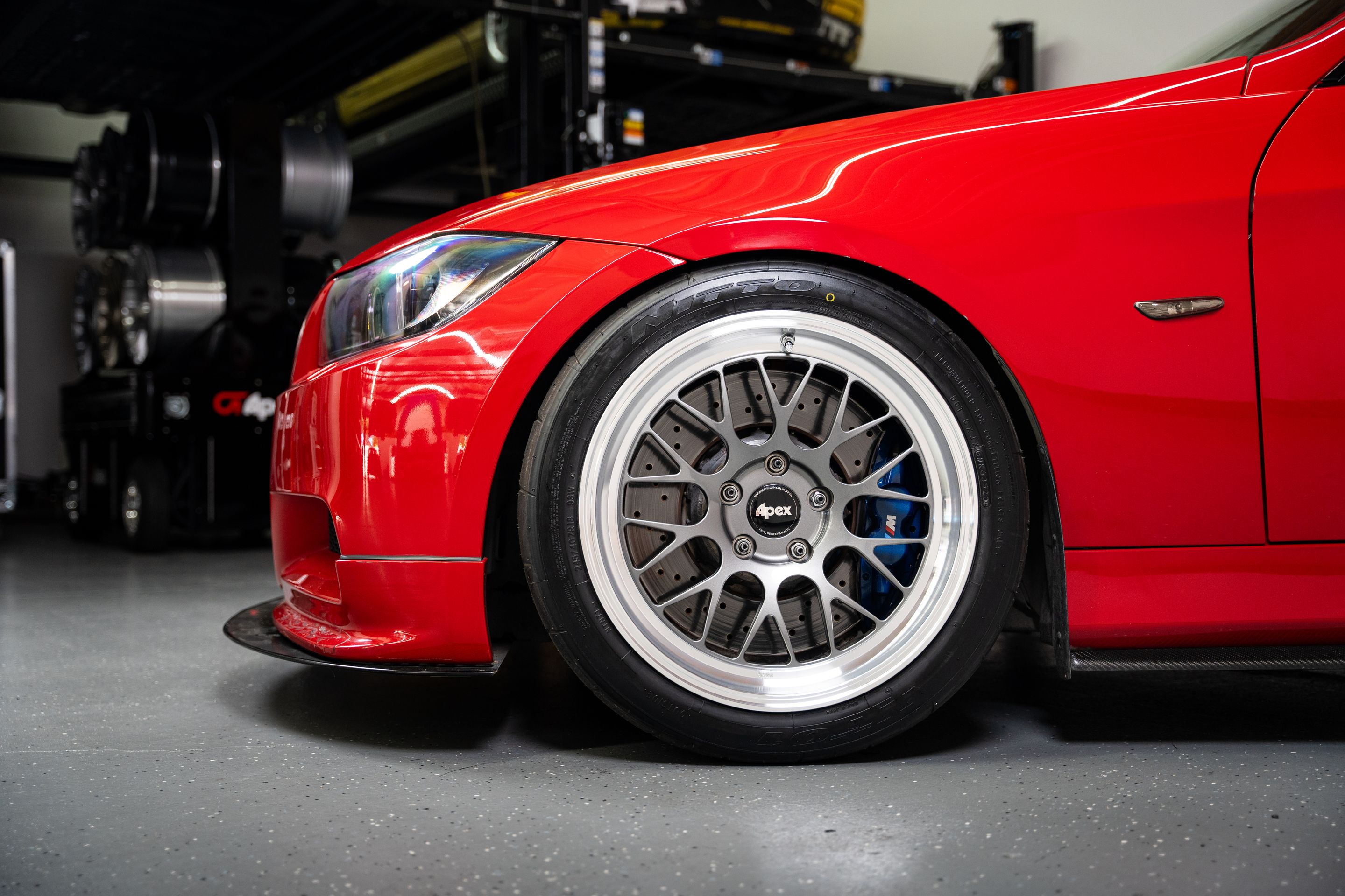 Red BMW E90 Sedan 3 Series with 18" ML-10RT Apex wheels in Machined Lip Anthracite