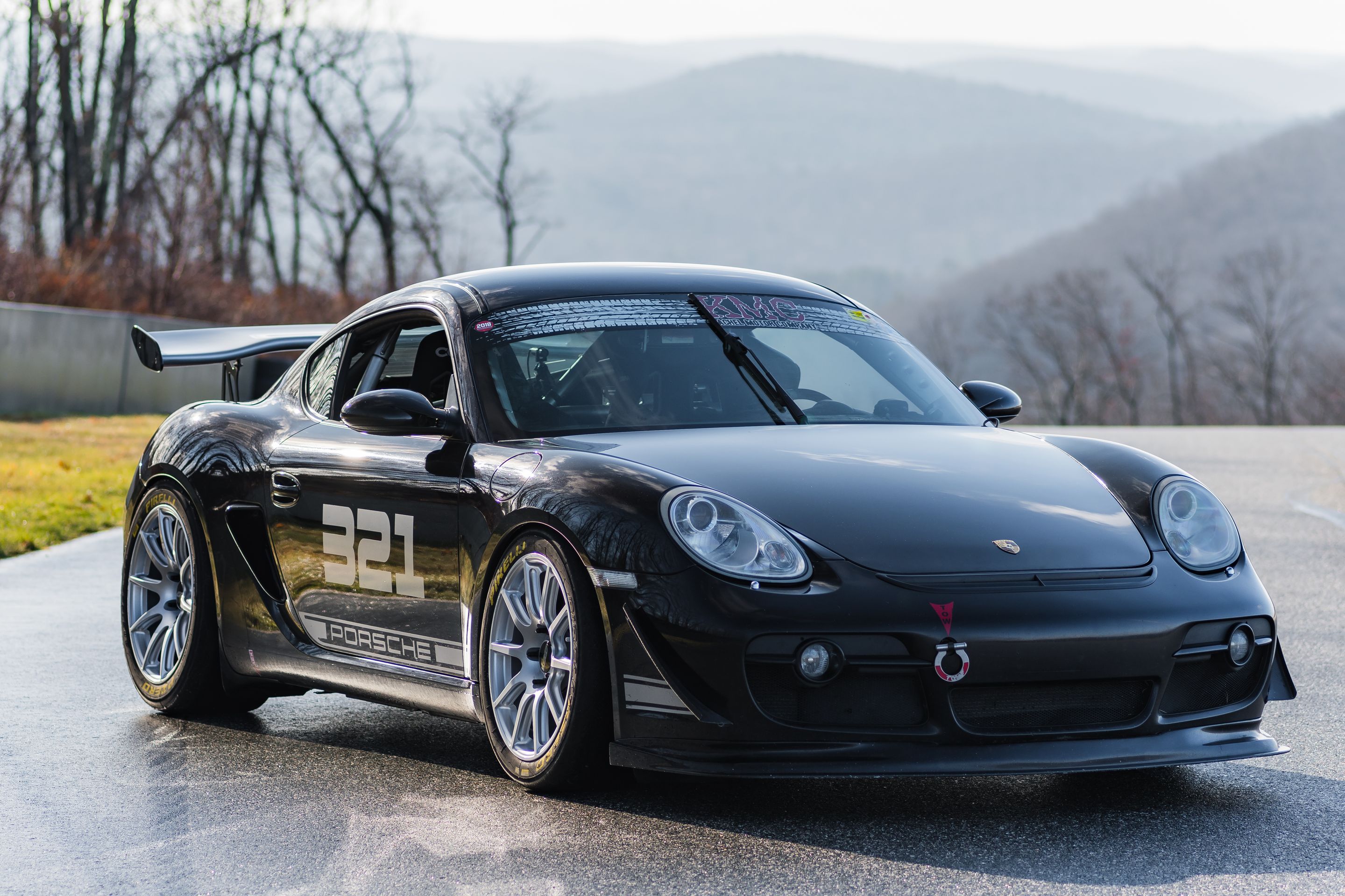 Black Porsche 987 Cayman S with 18" SM-10 Apex wheels in Race Silver