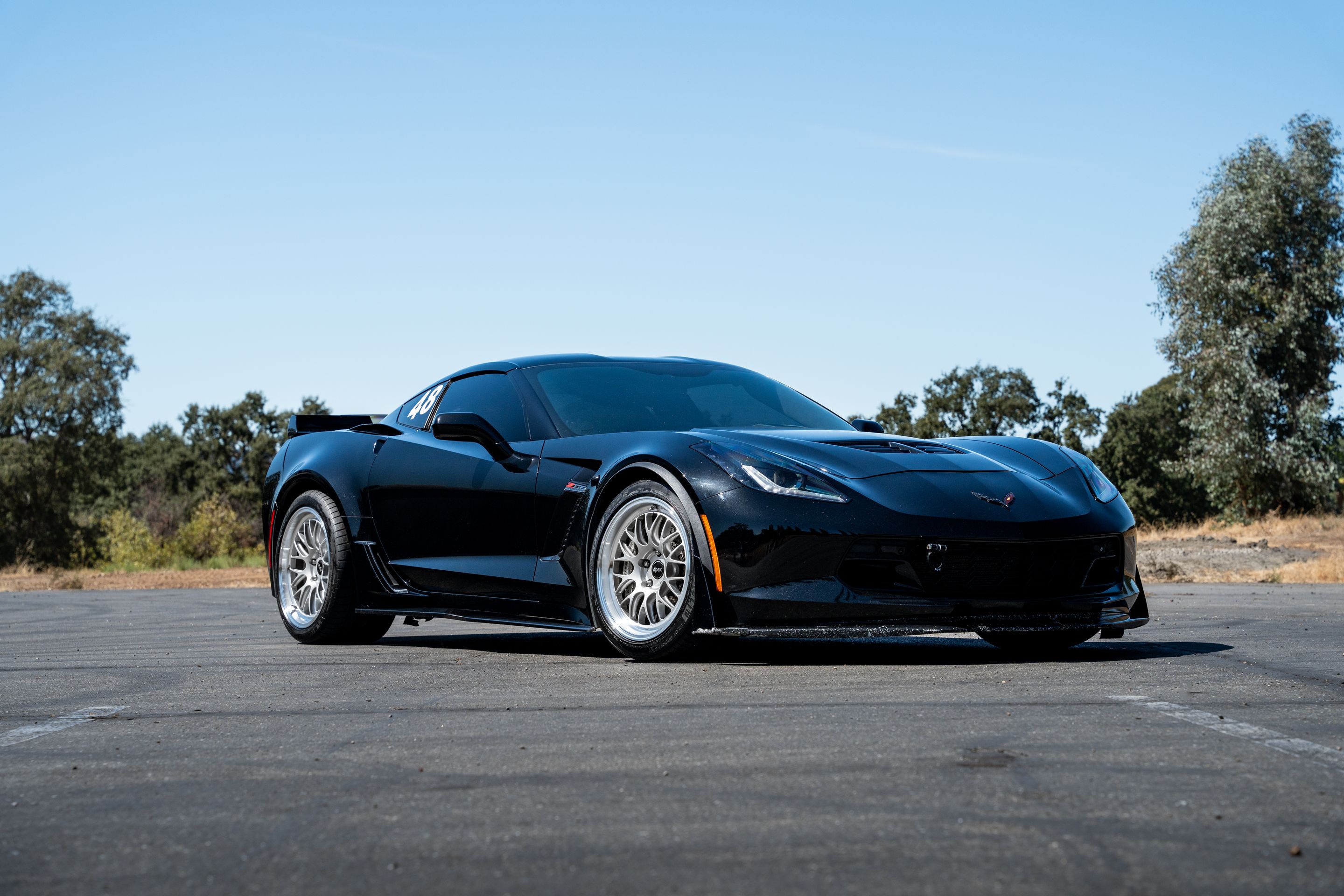 Black Chevrolet C7 Corvette Z06 with 18"/19" ML-10RT Apex wheels in Machined Lip Race Silver