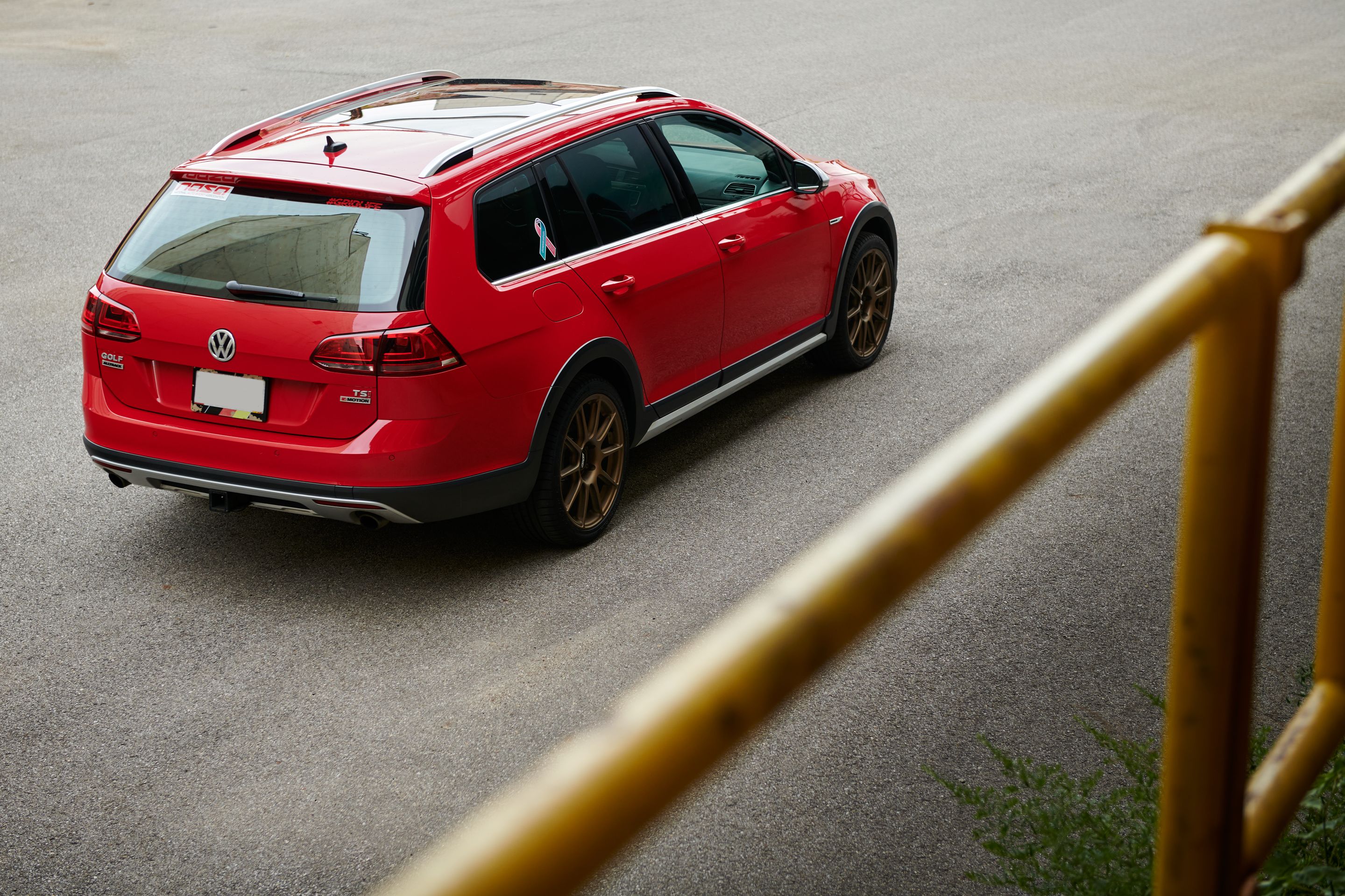 Red VW MK7 Alltrack/SportWagen Alltrack with 18" SM-10 Apex wheels in Satin Bronze