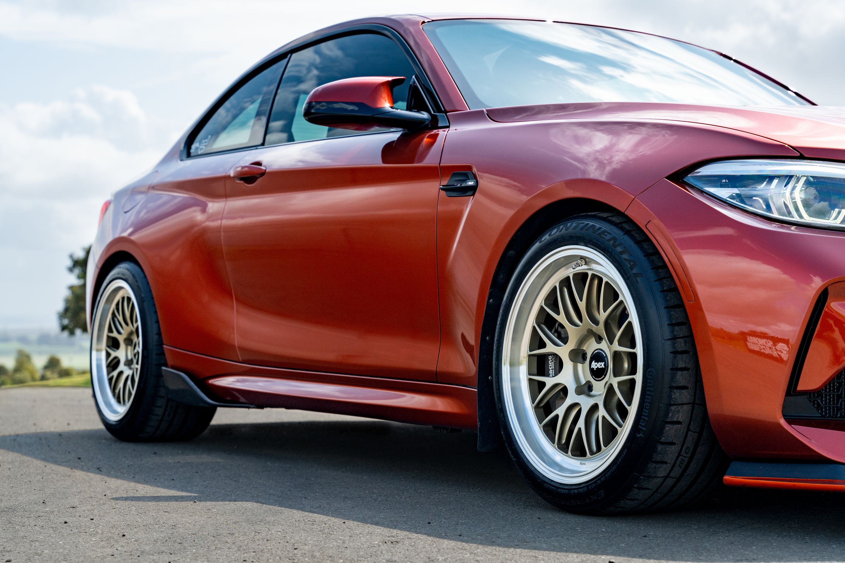 Orange BMW F87 M2 with 18" ML-10RT Apex wheels in Machined Lip Gloss Motorsport Gold
