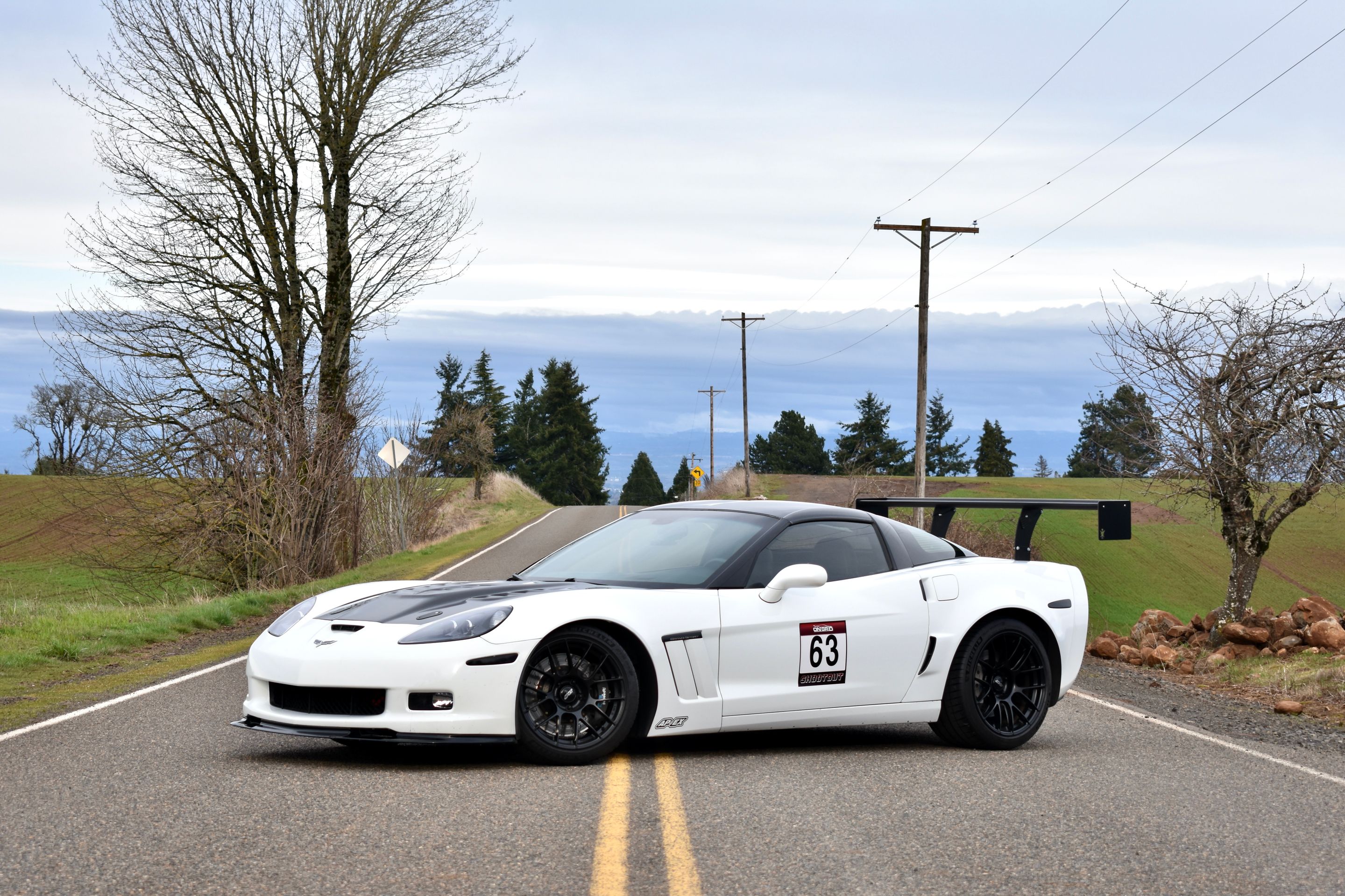 White Chevrolet C6 Corvette Grand Sport with 18"/19" EC-7RS Apex wheels in Satin Black