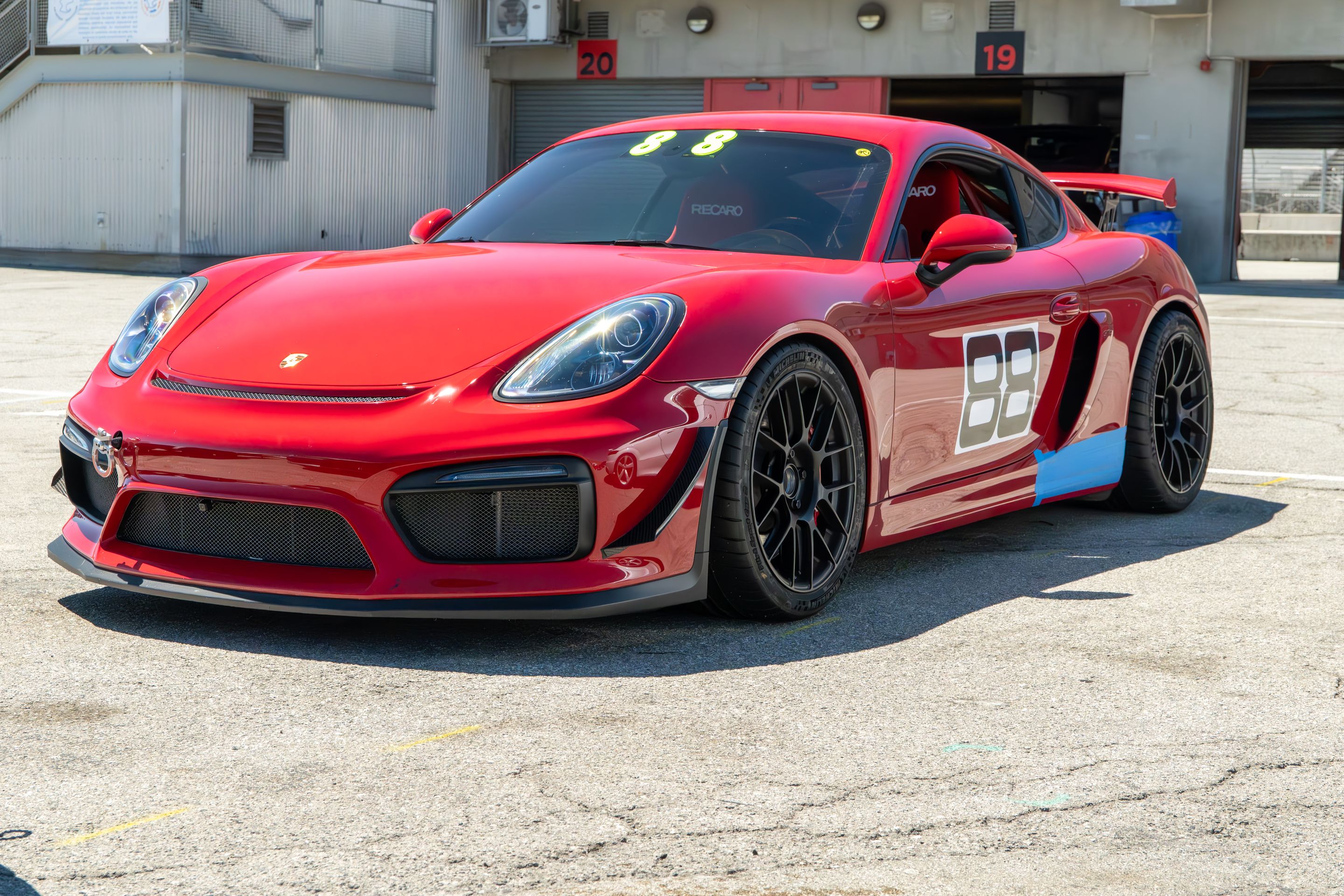 Red Porsche 981 Cayman GT4 with 19" EC-7RS Apex wheels in Satin Black