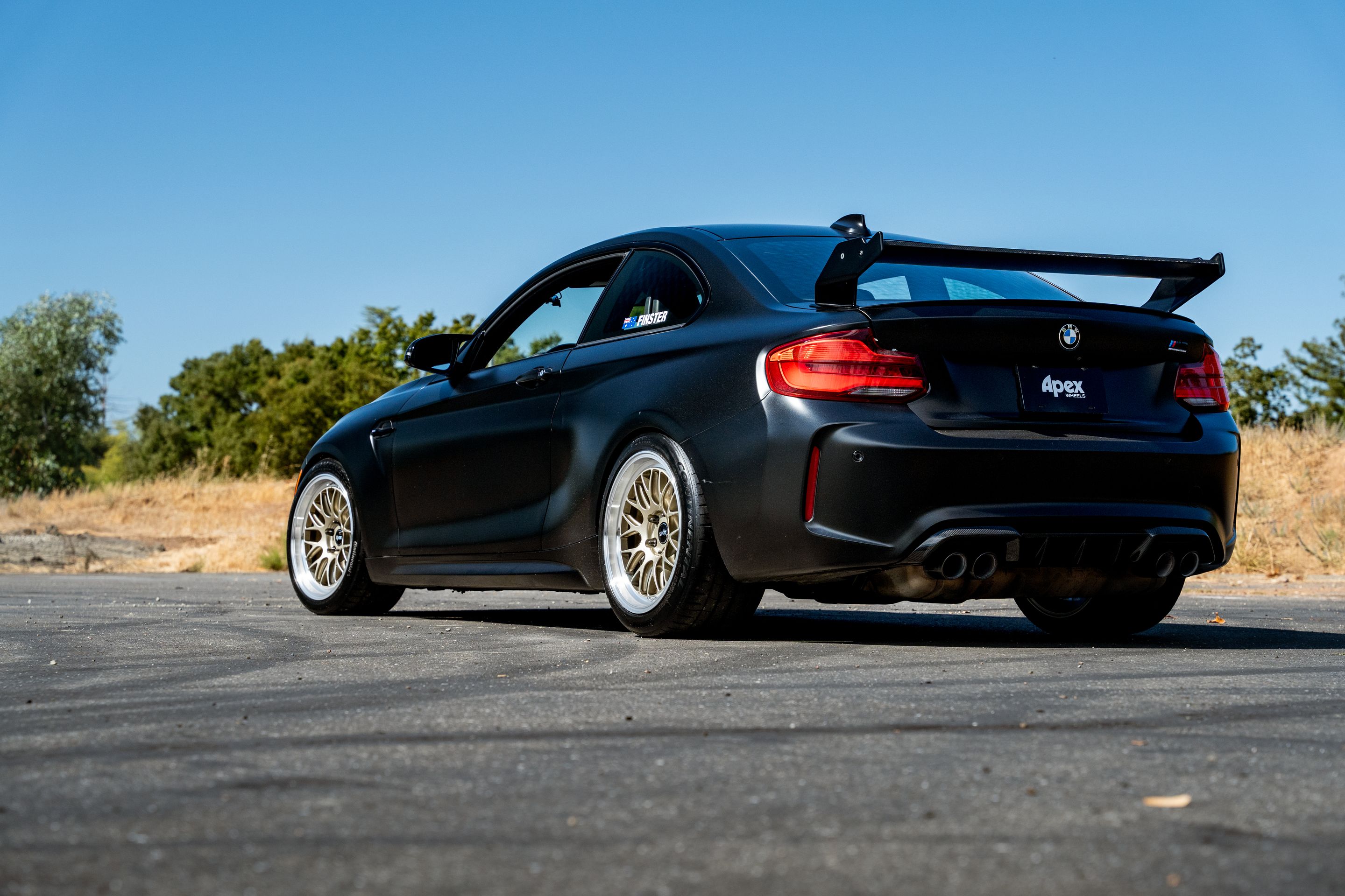 Black BMW F87 M2 with 18" ML-10RT Apex wheels in Machined Lip Gloss Motorsport Gold