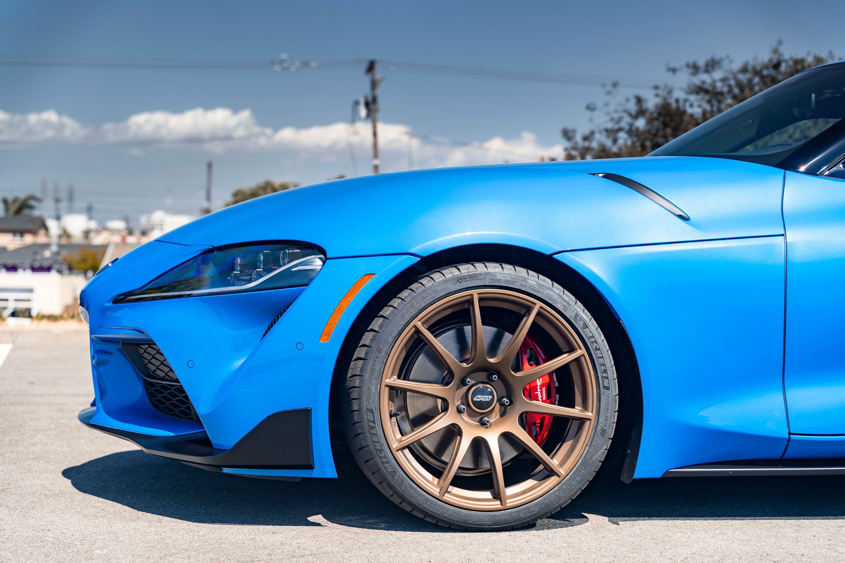Blue Toyota GR Supra with 19" SM-10 Apex wheels in Satin Bronze