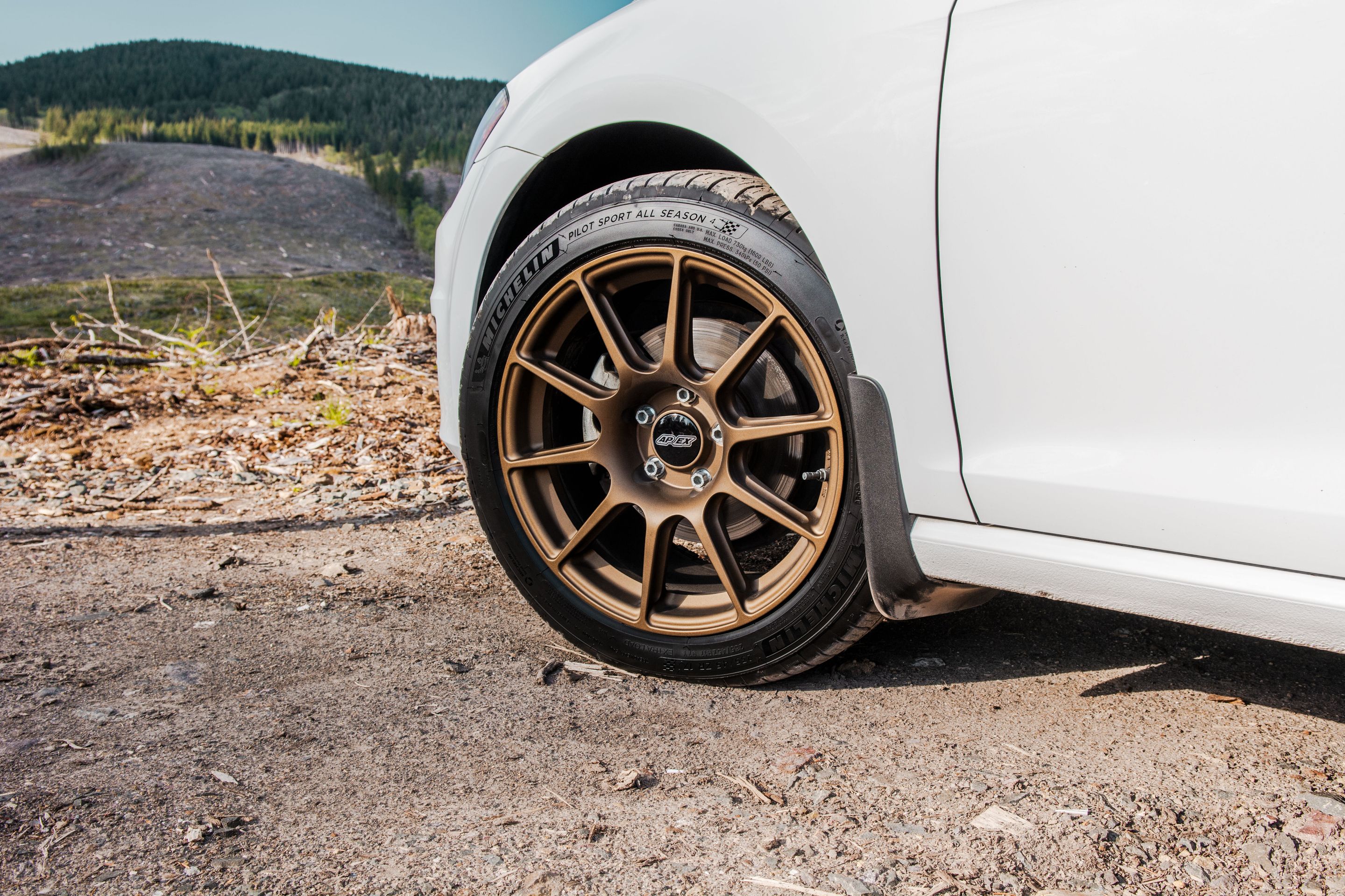 White VW MK7 Alltrack/SportWagen Golf SportWagen with 17" SM-10 Apex wheels in Satin Bronze