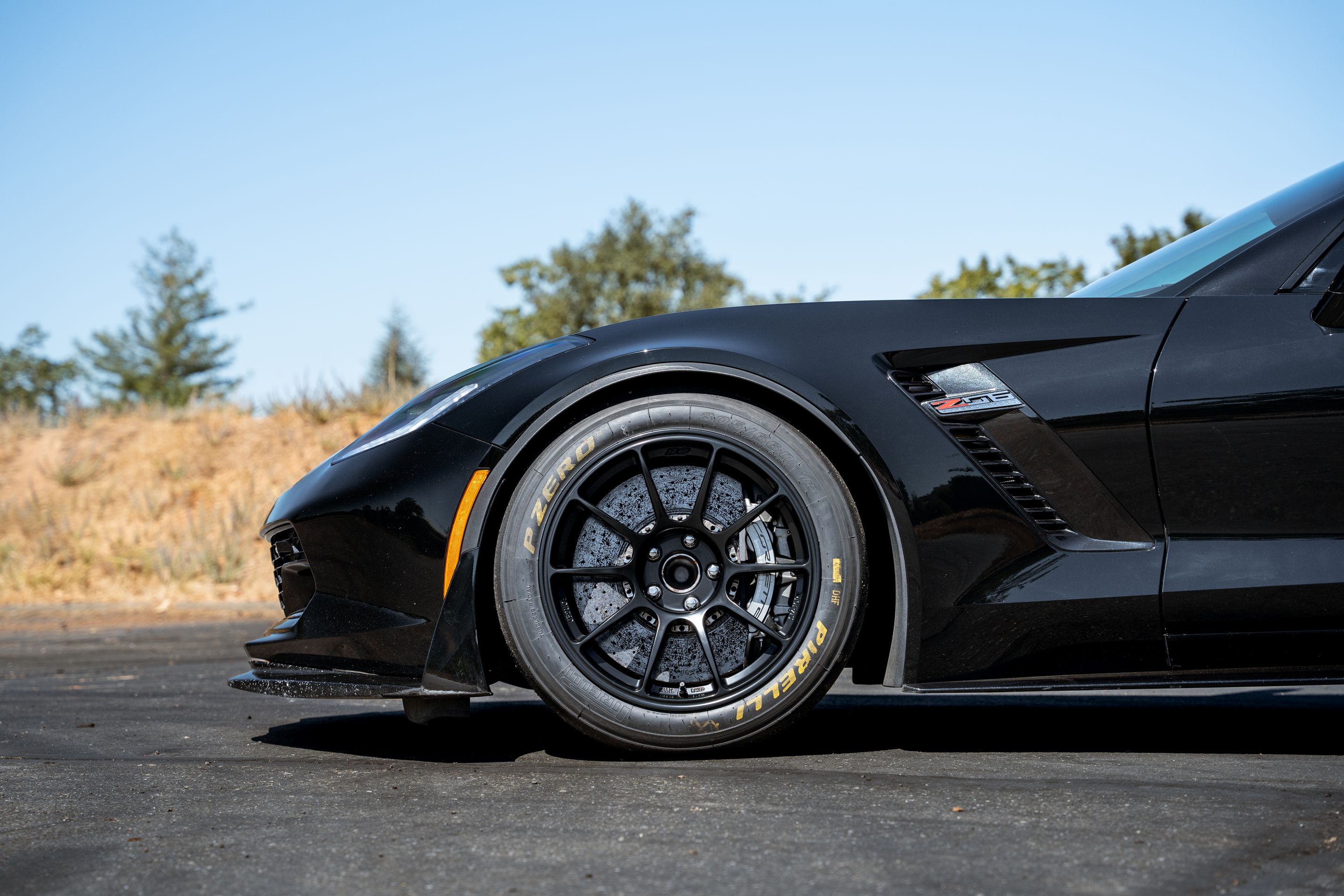 Black Chevrolet C7 Corvette Z06 with 18" SM-10RE Apex wheels in Satin Black