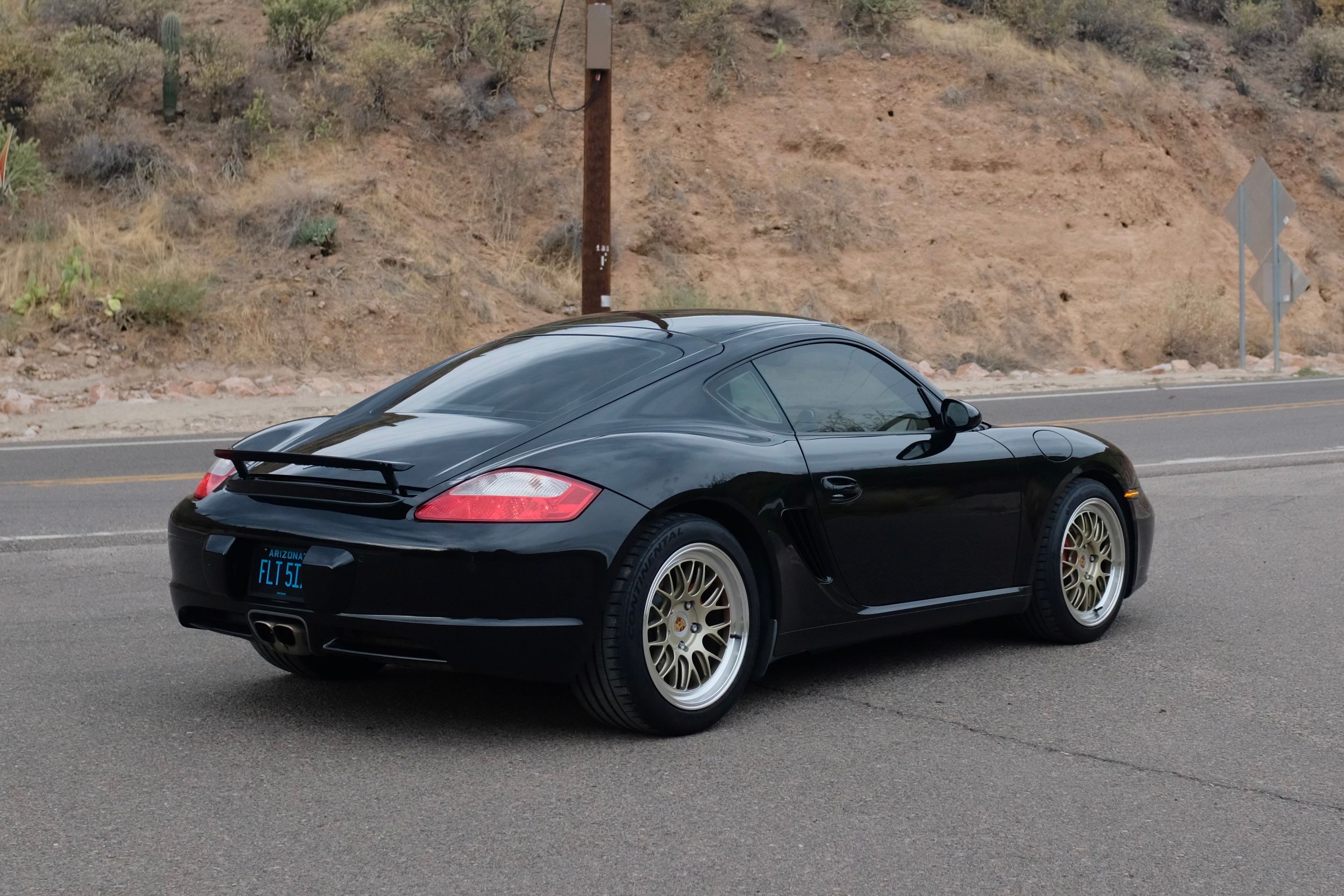 Black Porsche 987 Cayman S with 18" ML-10RT Apex wheels in Machined Lip Gloss Motorsport Gold