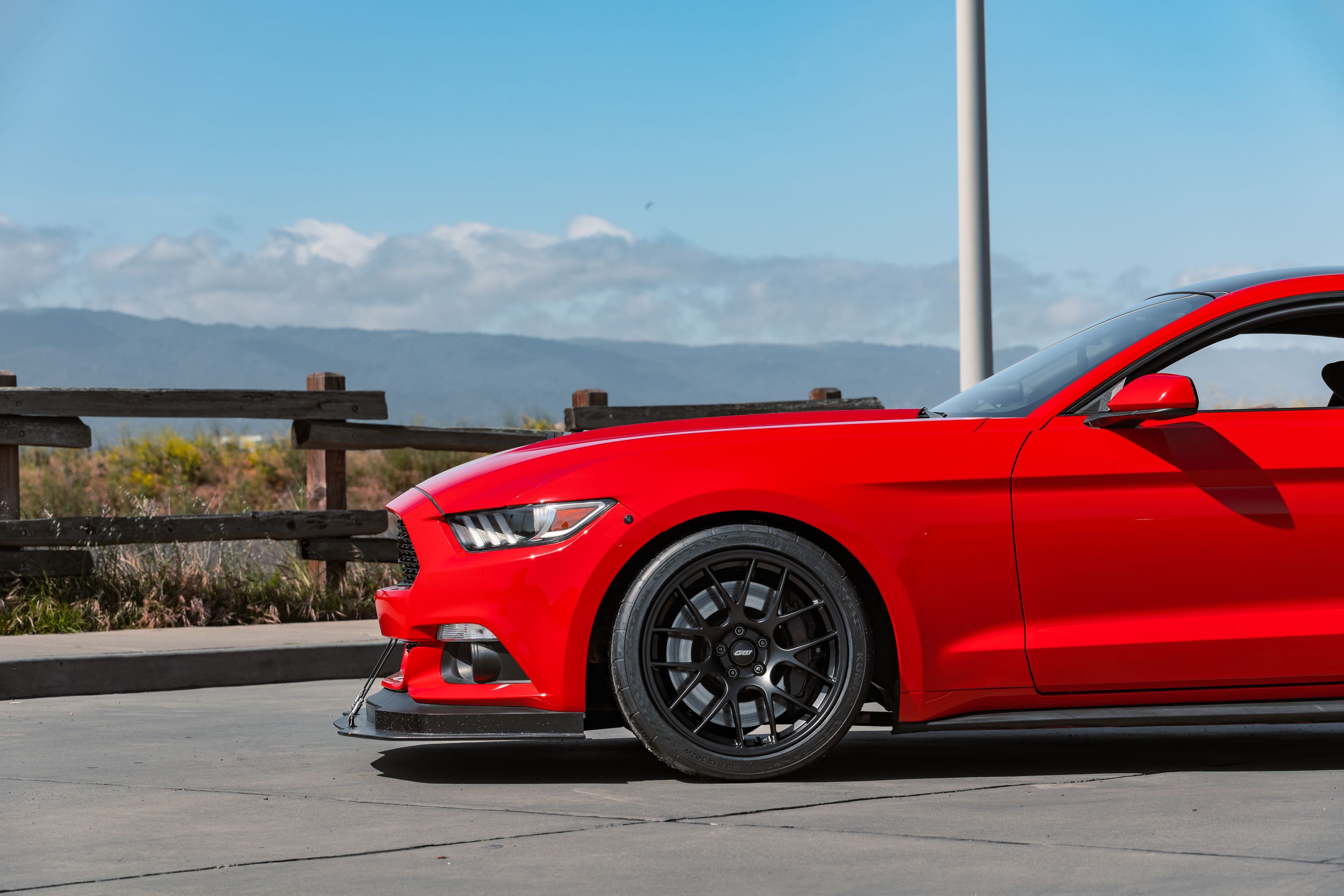 Red Ford S550 Mustang GT with 19" EC-7 Apex wheels in Satin Black